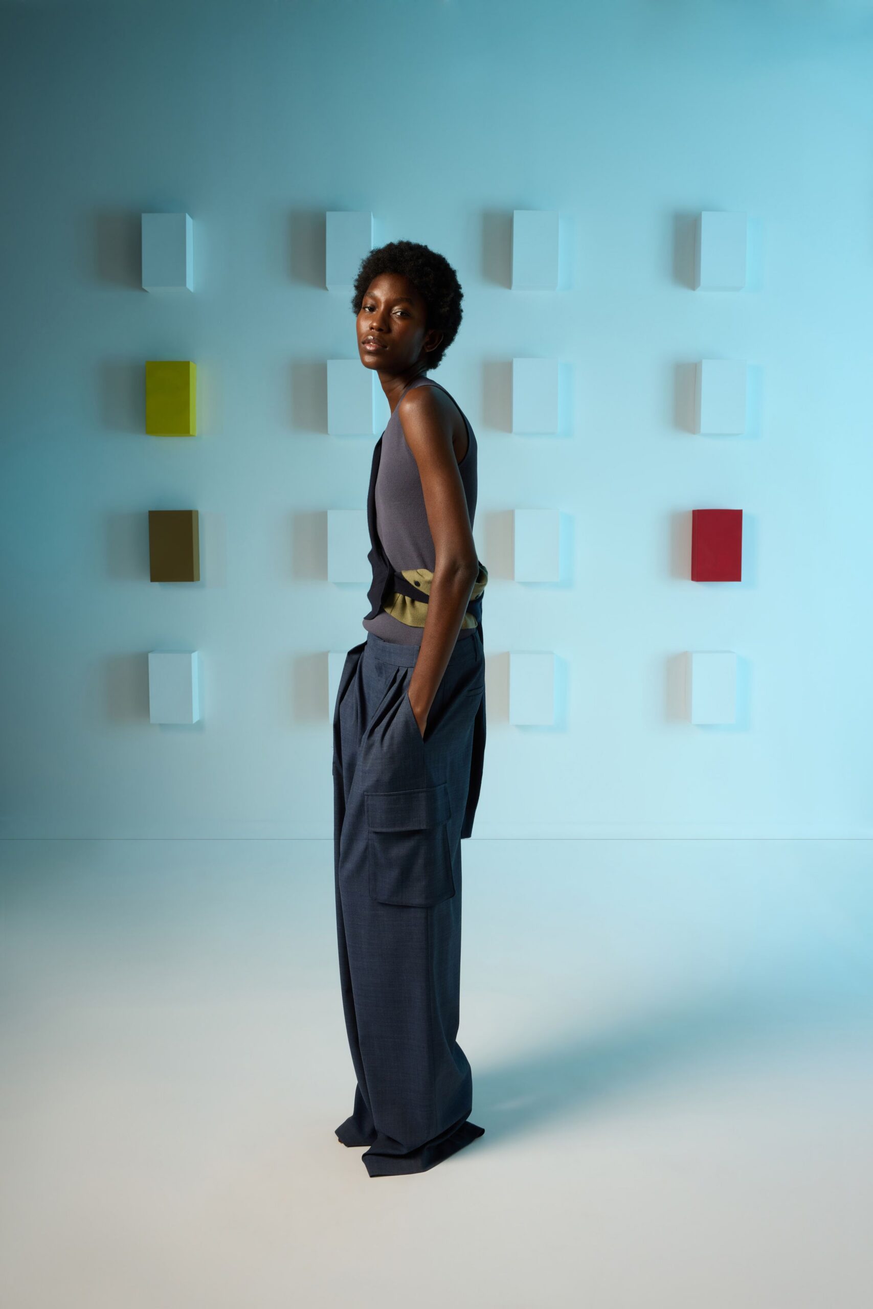 gray fitted sleeveless top with blue relaxed cargo pants