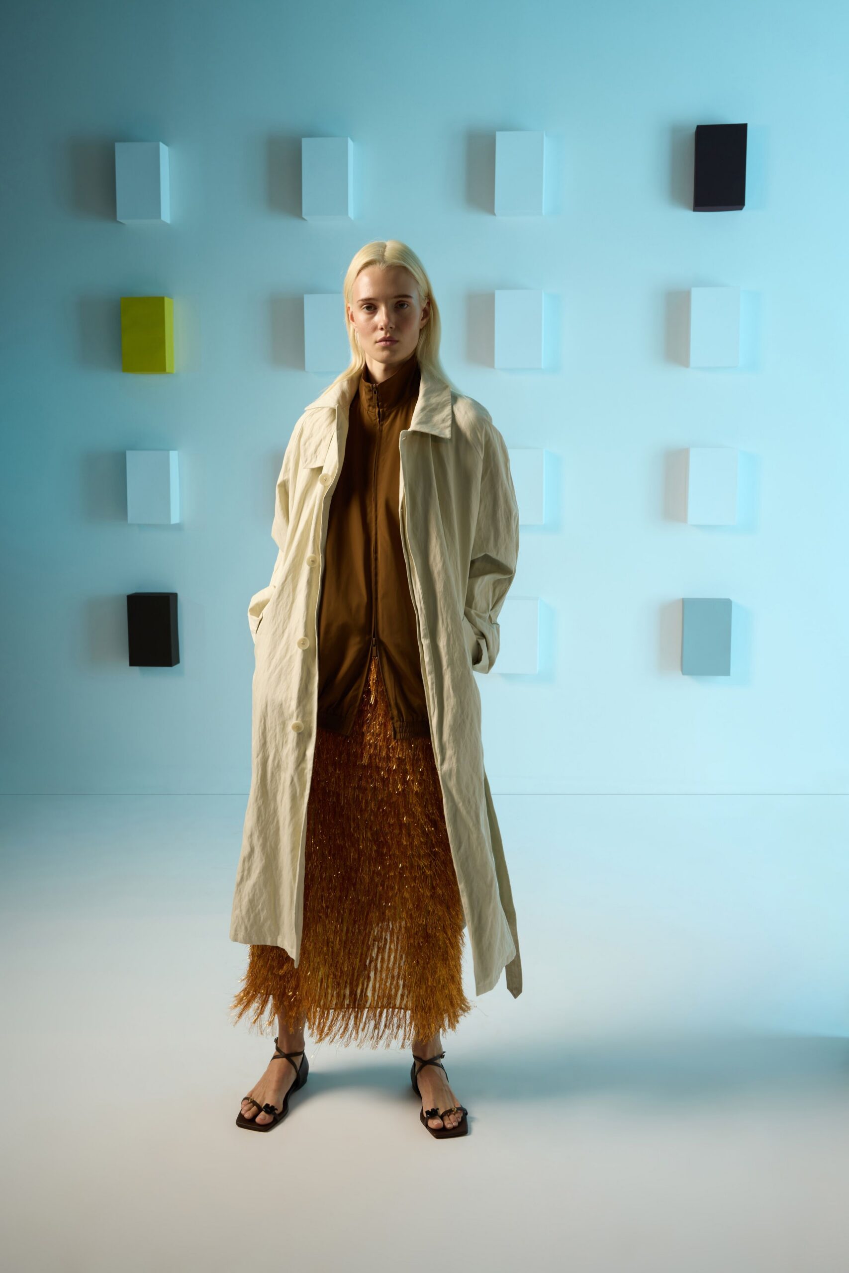 beige coat brown top gold skirt