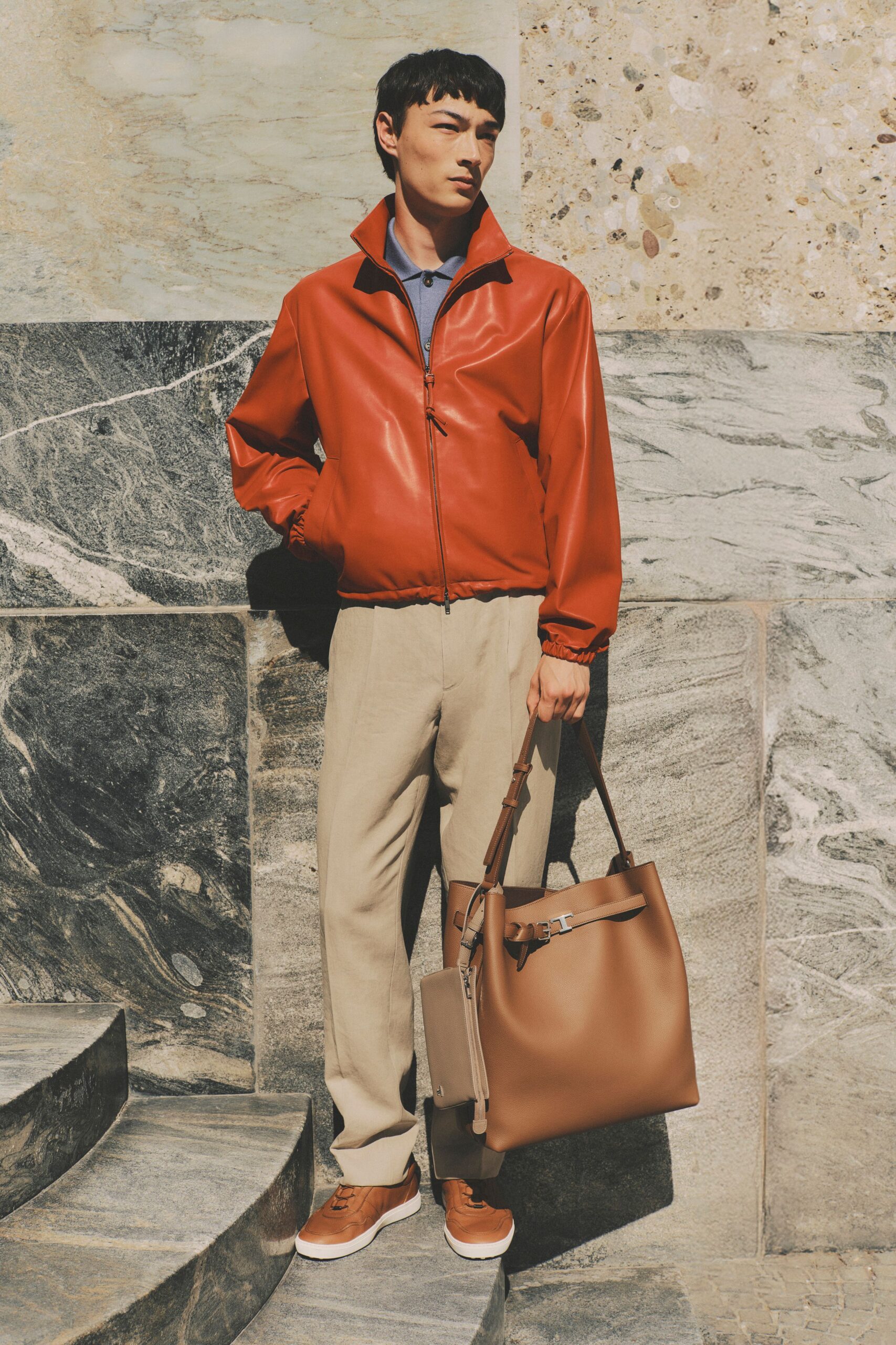 red leather jacket with beige pants