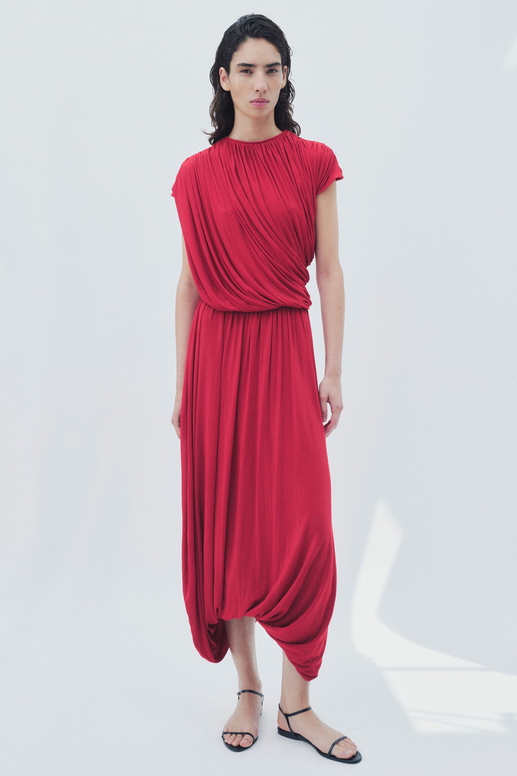 red silk sleeveless high-neck fitted draped flowing dress