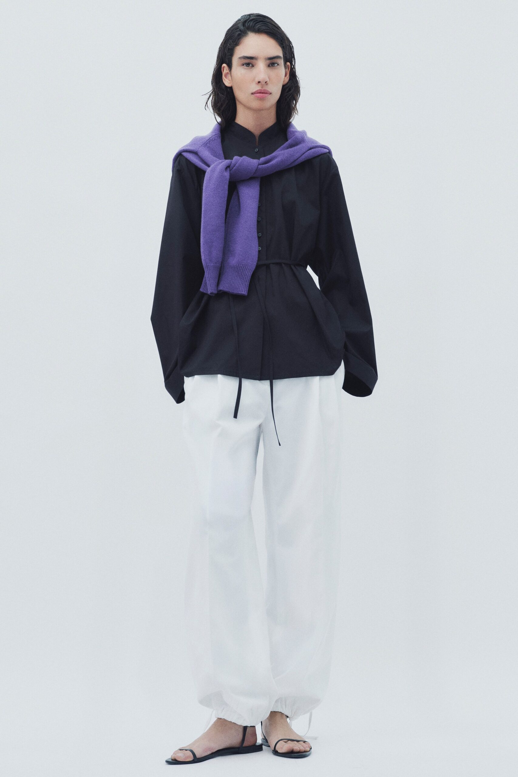 black shirt white pants purple sweater