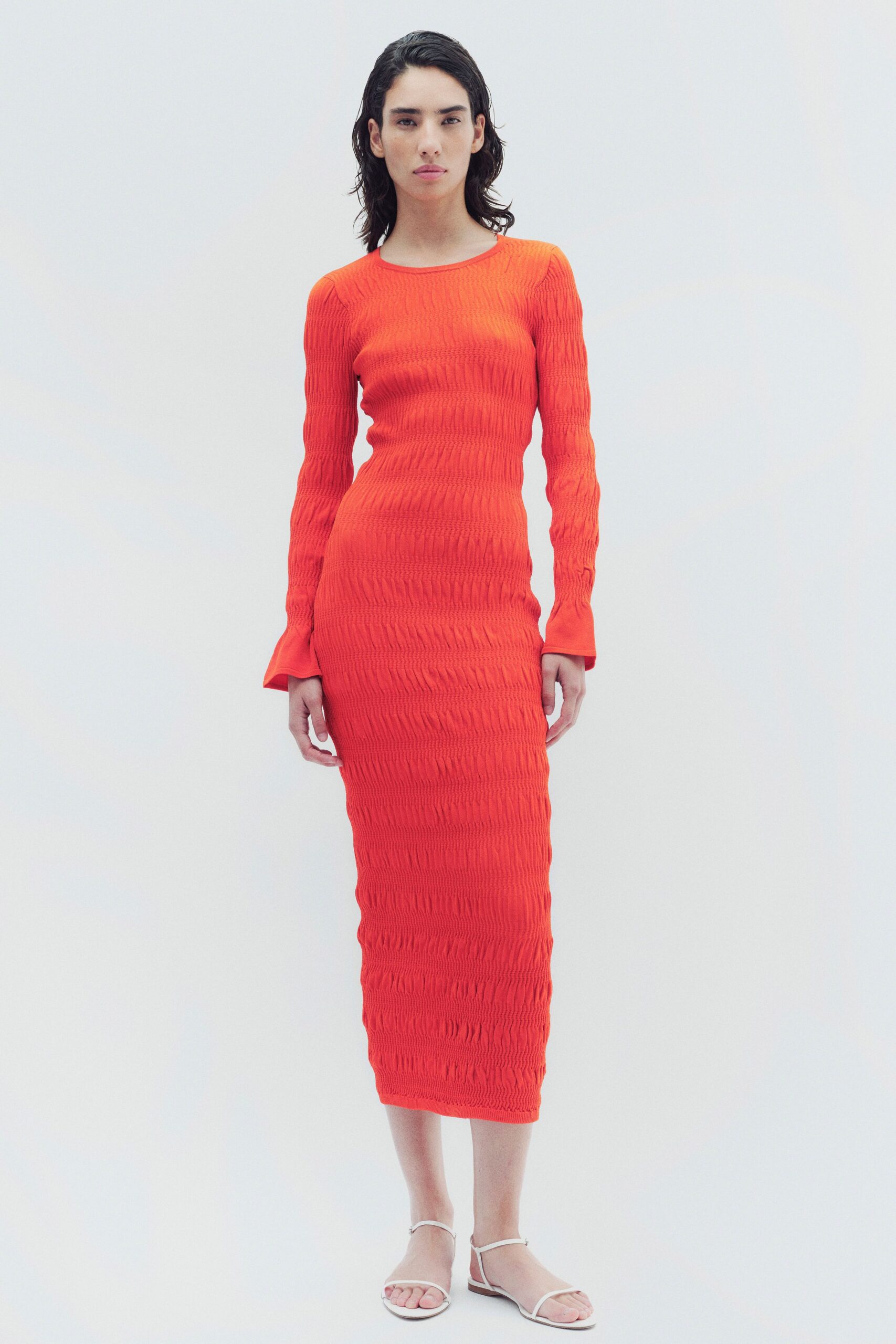 fitted orange midi dress with long sleeves