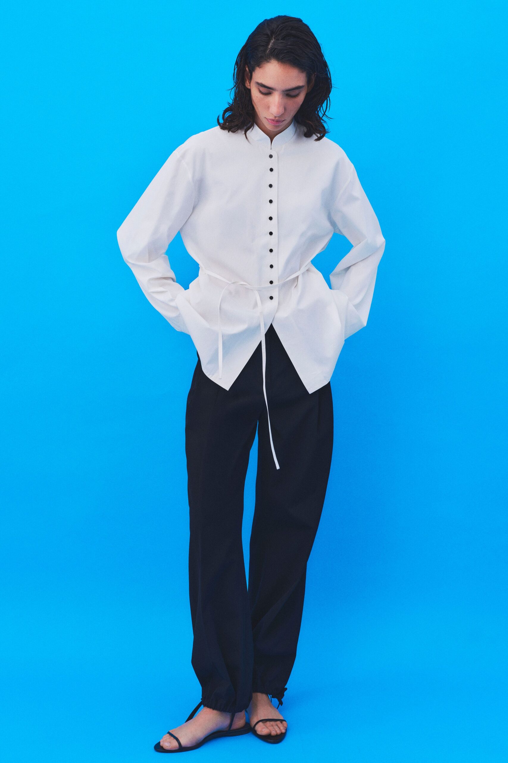 white relaxed shirt black pants sandals