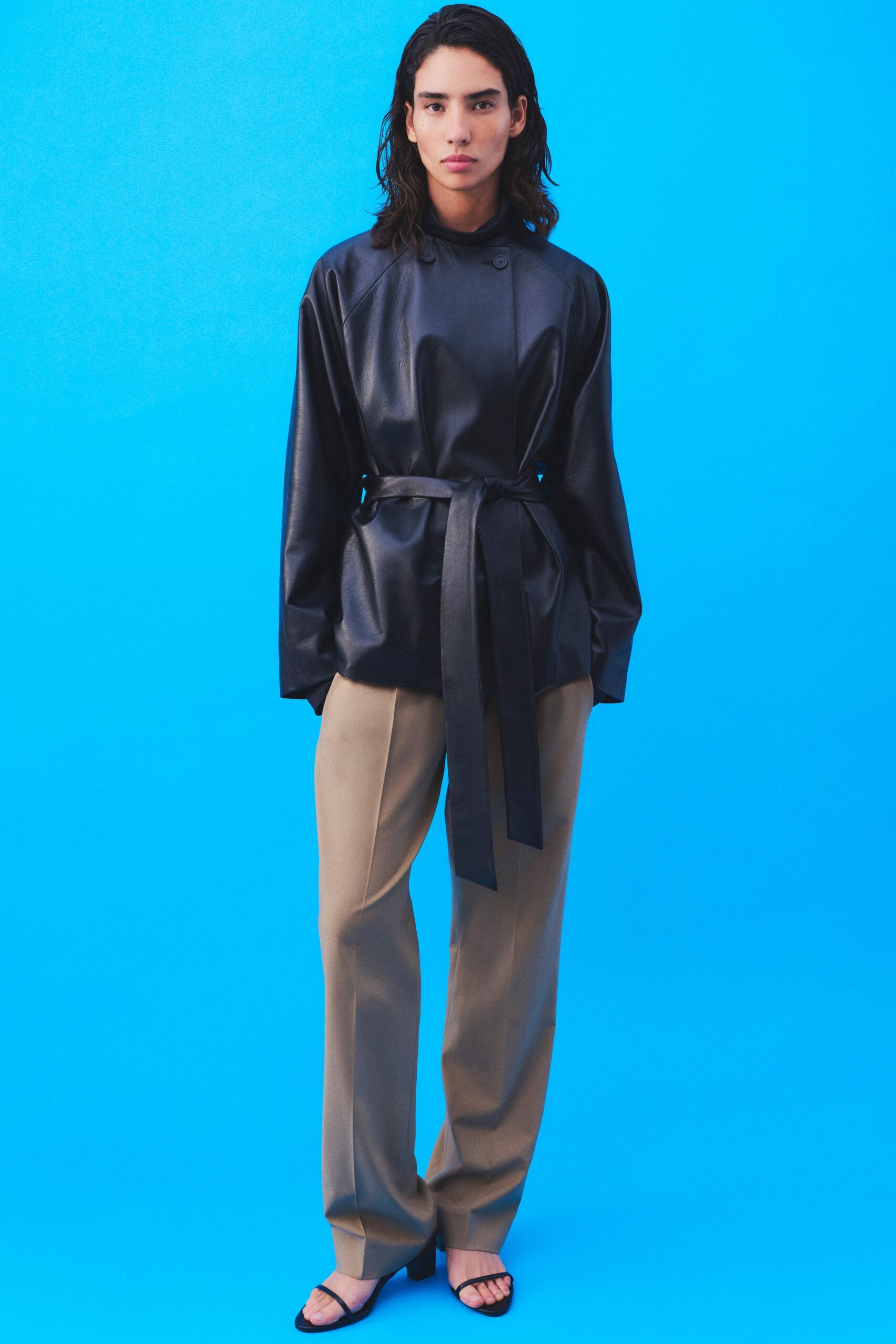 black leather jacket beige tailored pants