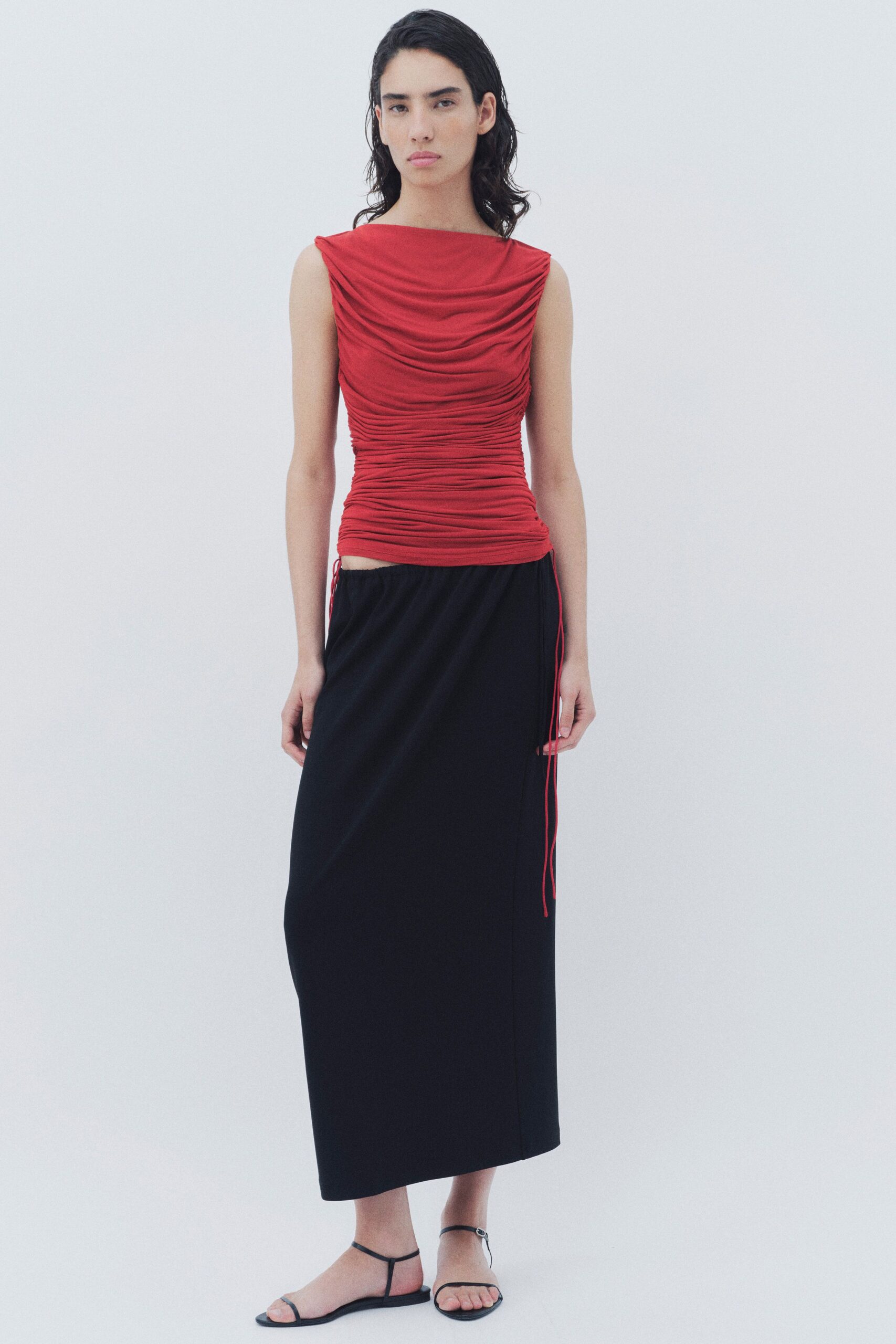 red fitted top black midi skirt