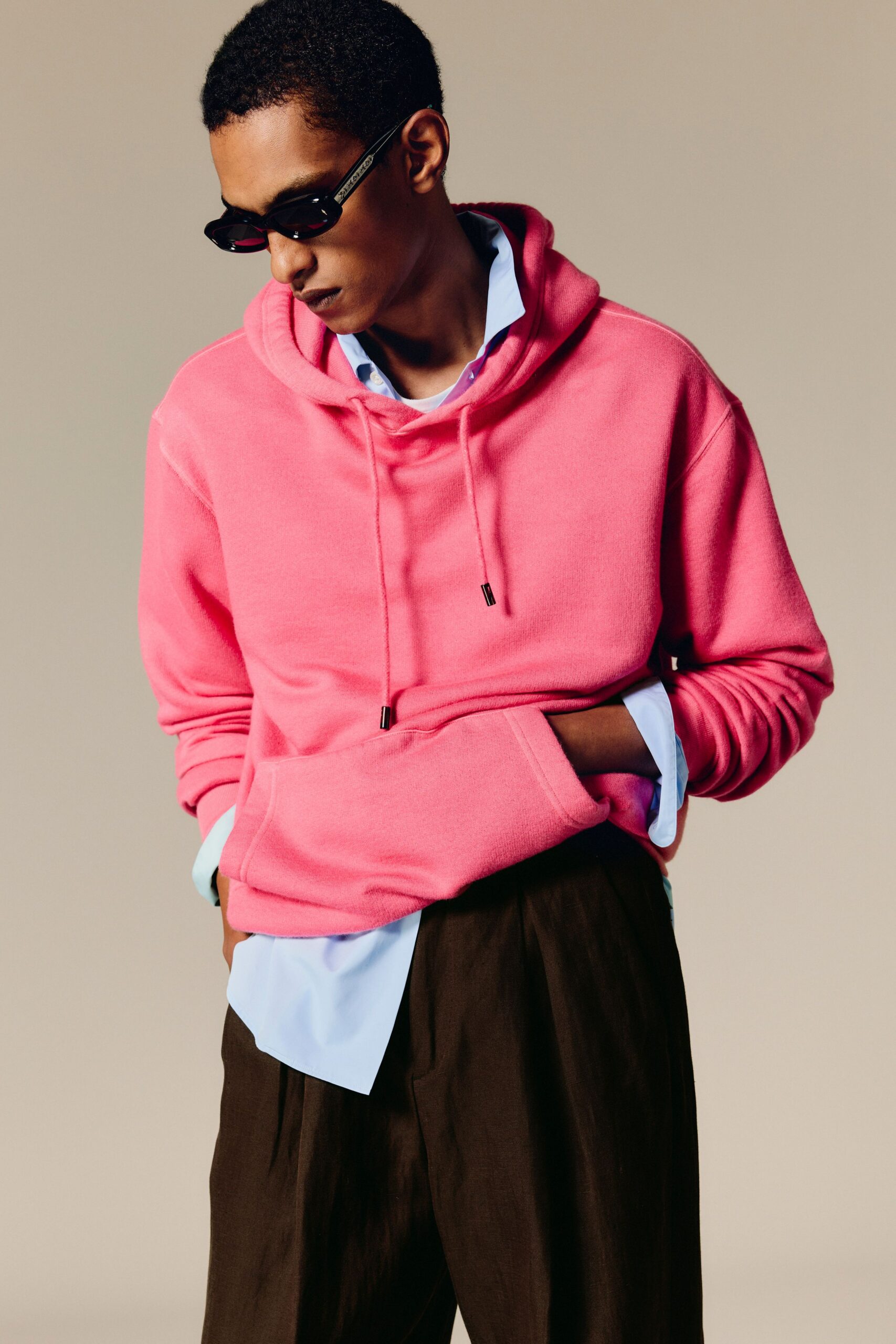 pink hoodie with blue shirt and brown pants