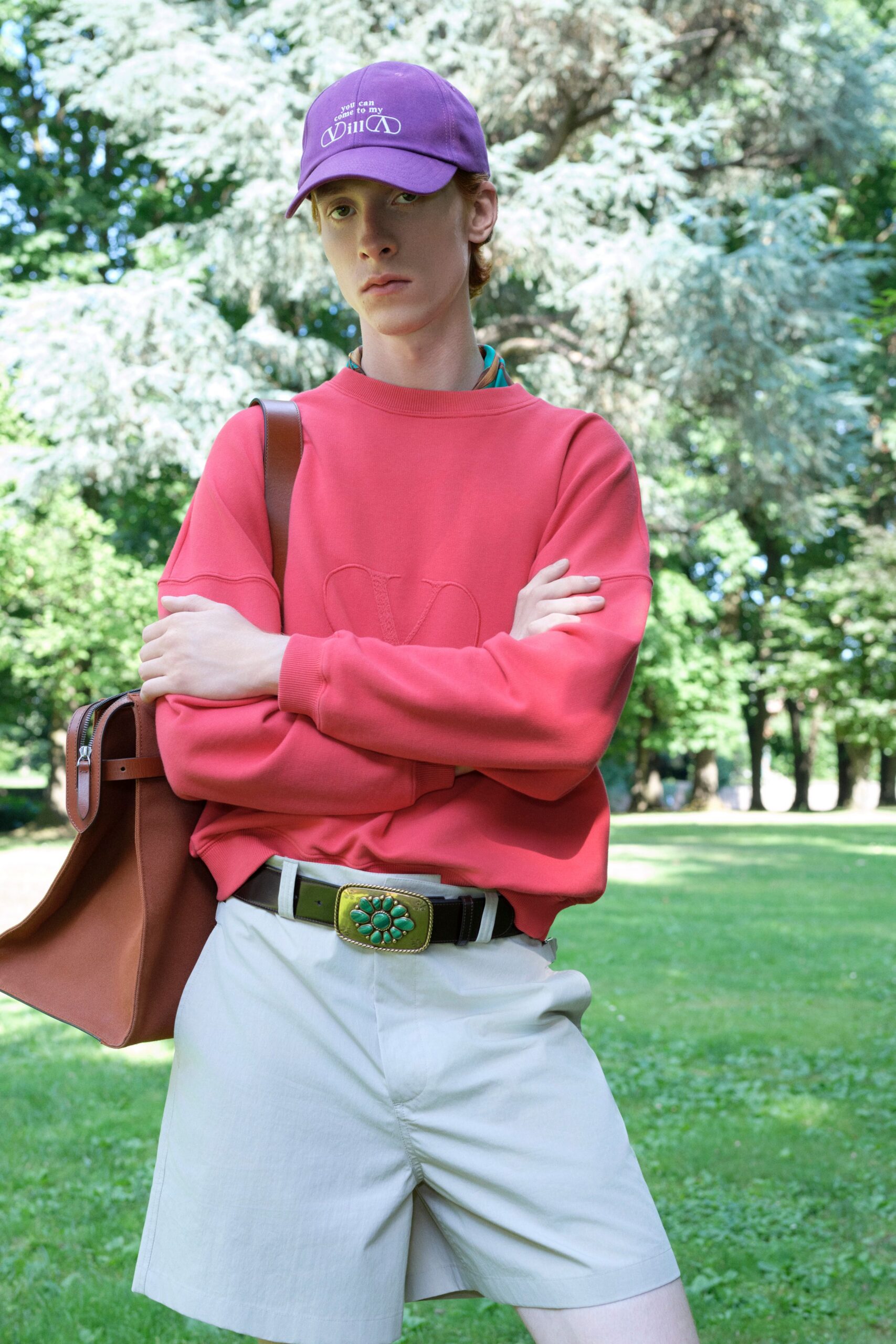 red relaxed sweater with beige shorts