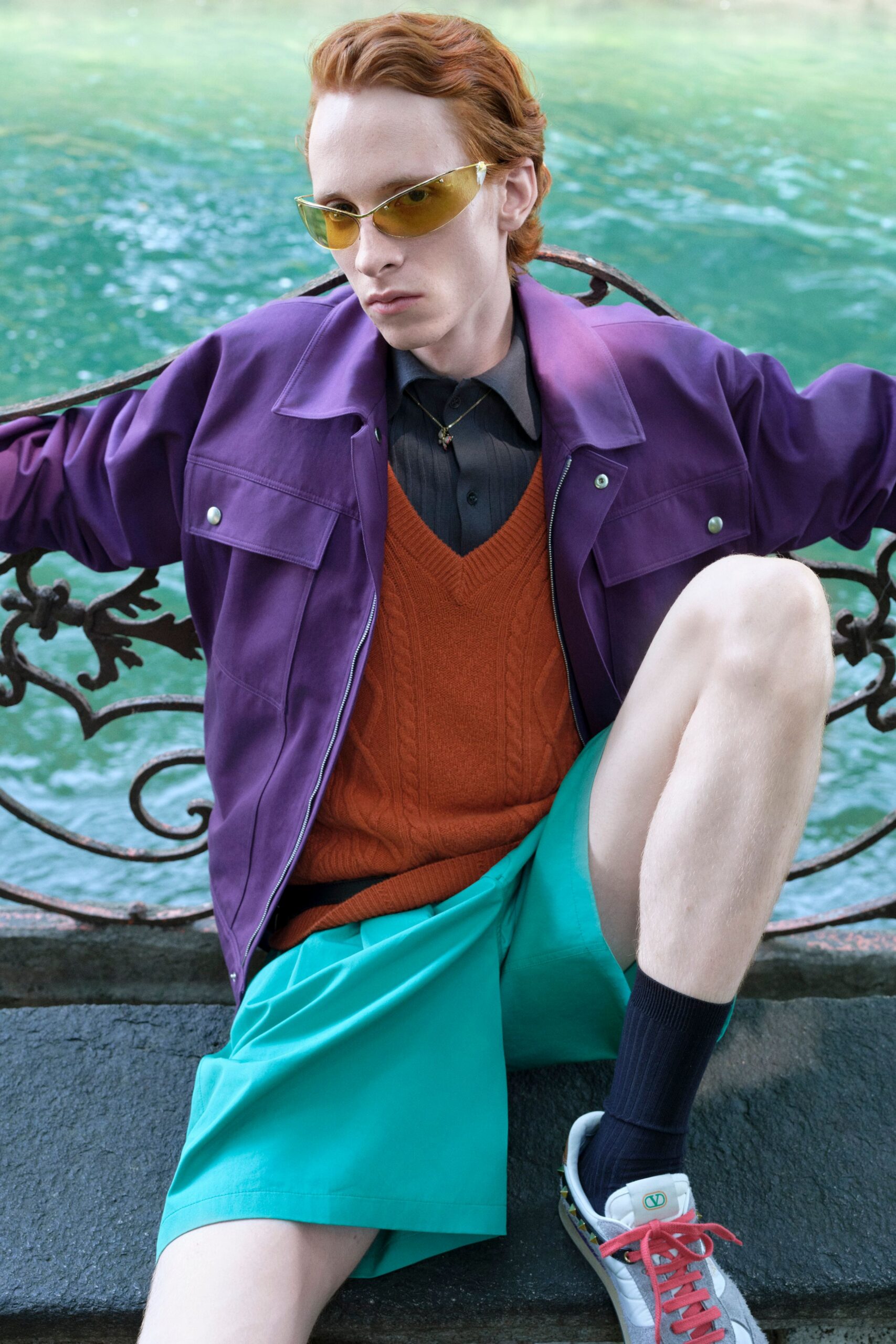 purple jacket orange sweater black shirt teal shorts