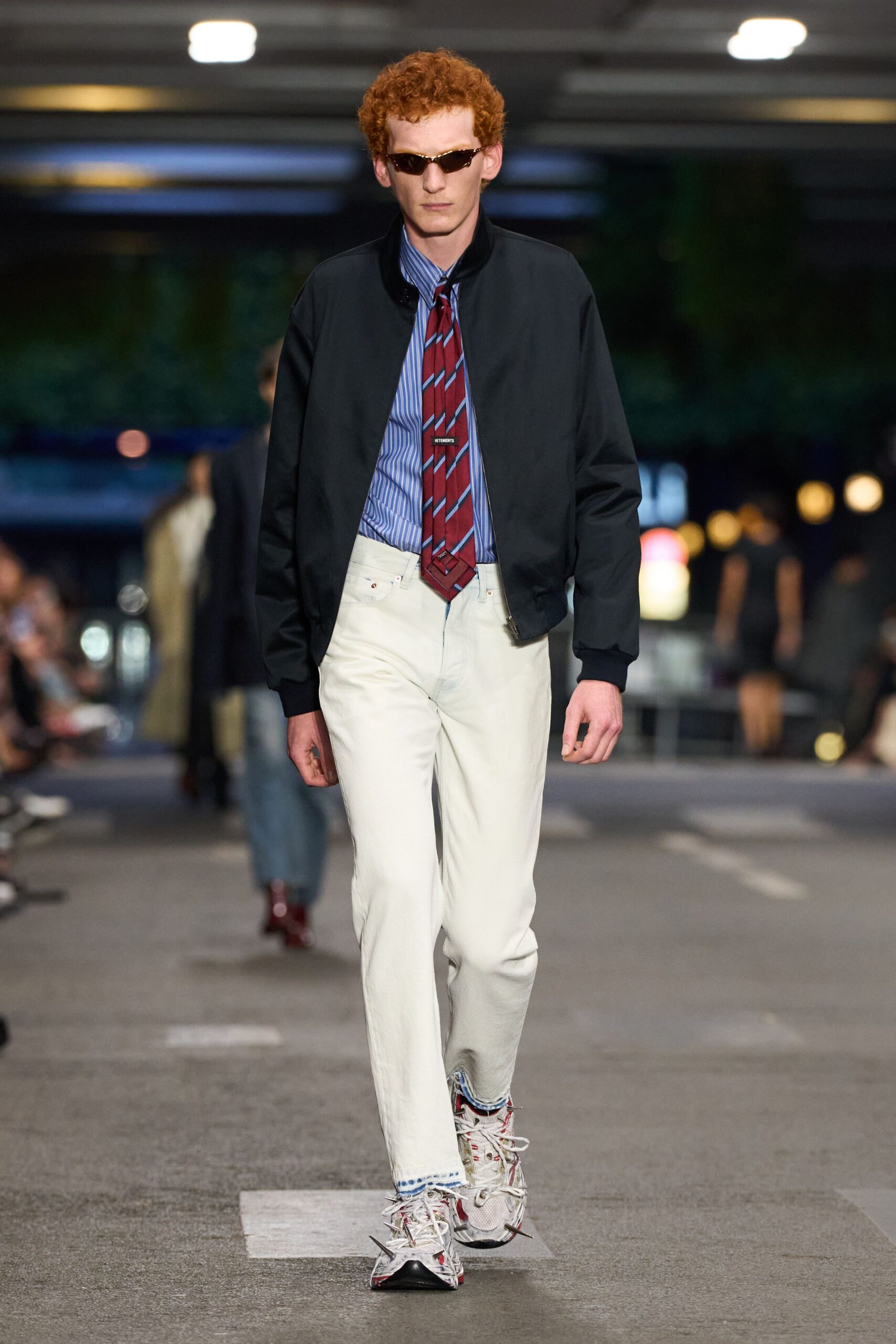 black jacket blue shirt white pants