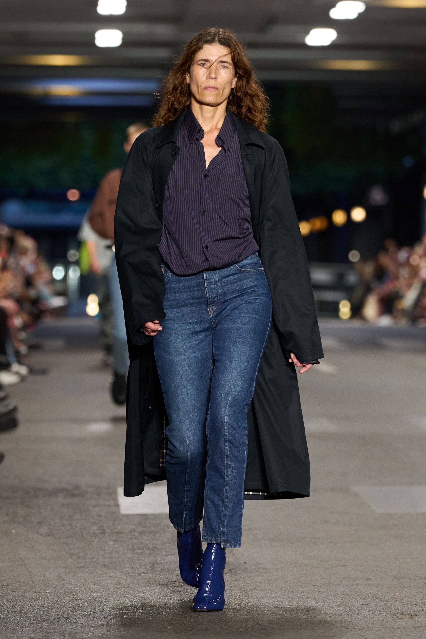 black coat blue shirt jeans boots