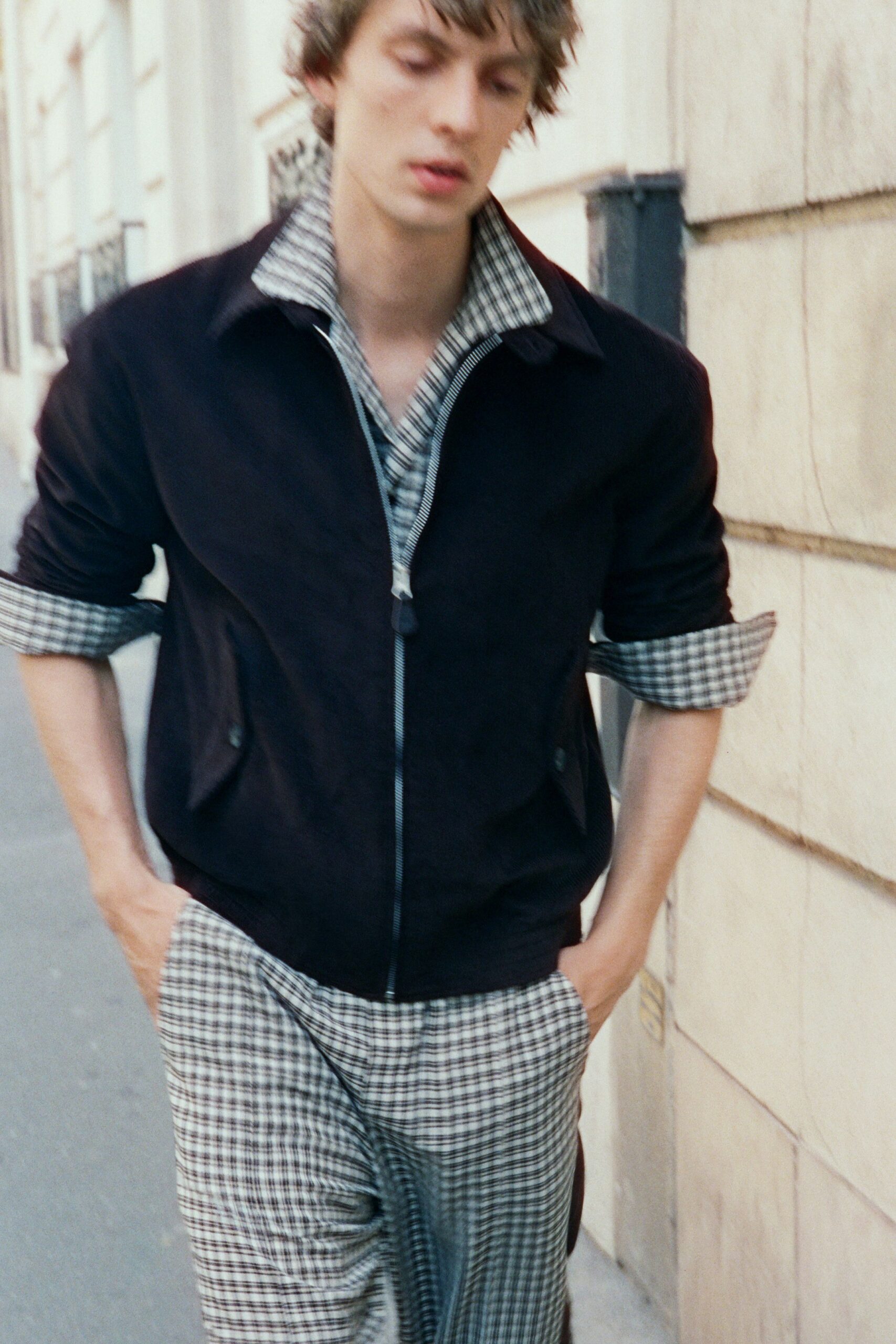 black suede jacket with checked shirt and pants