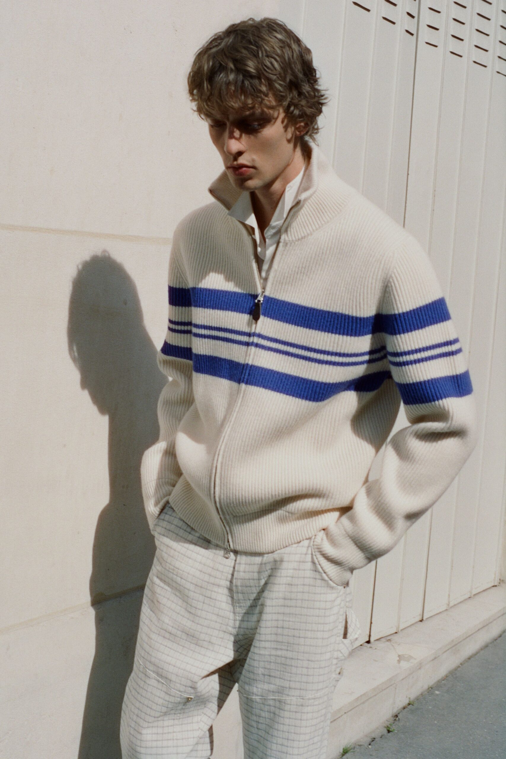 white and blue striped sweater with beige pants