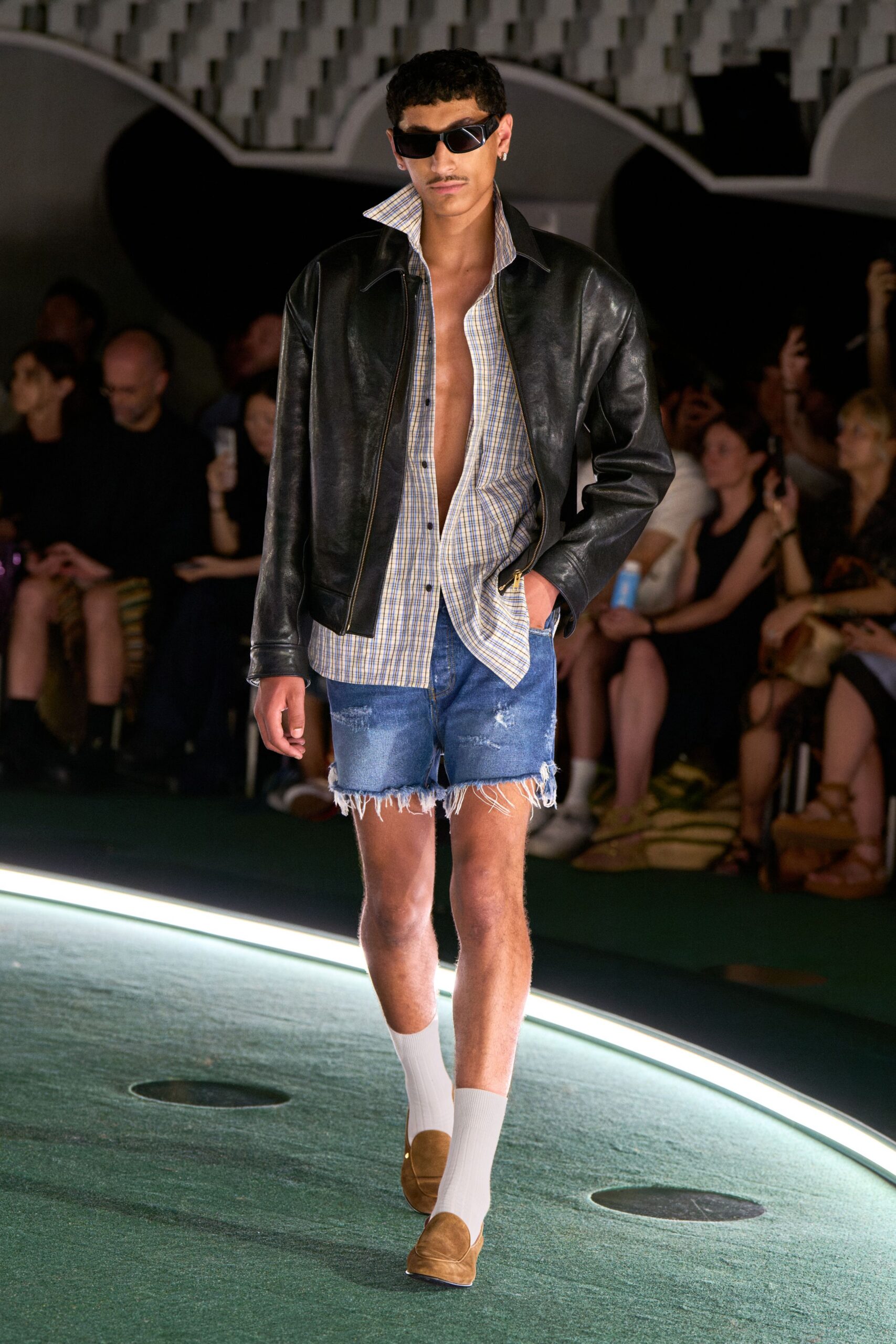 black leather jacket with denim shorts
