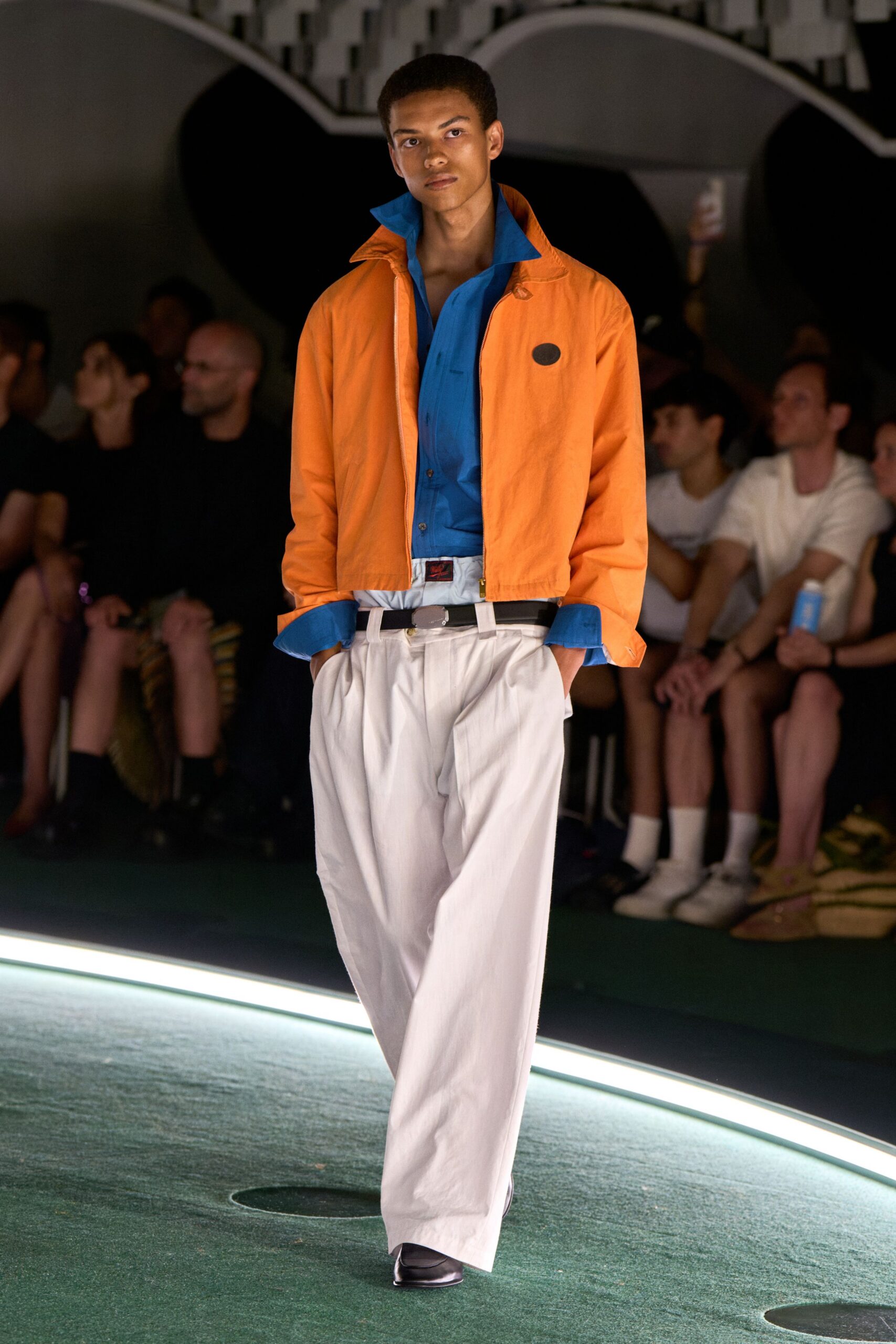 orange jacket blue shirt white pants