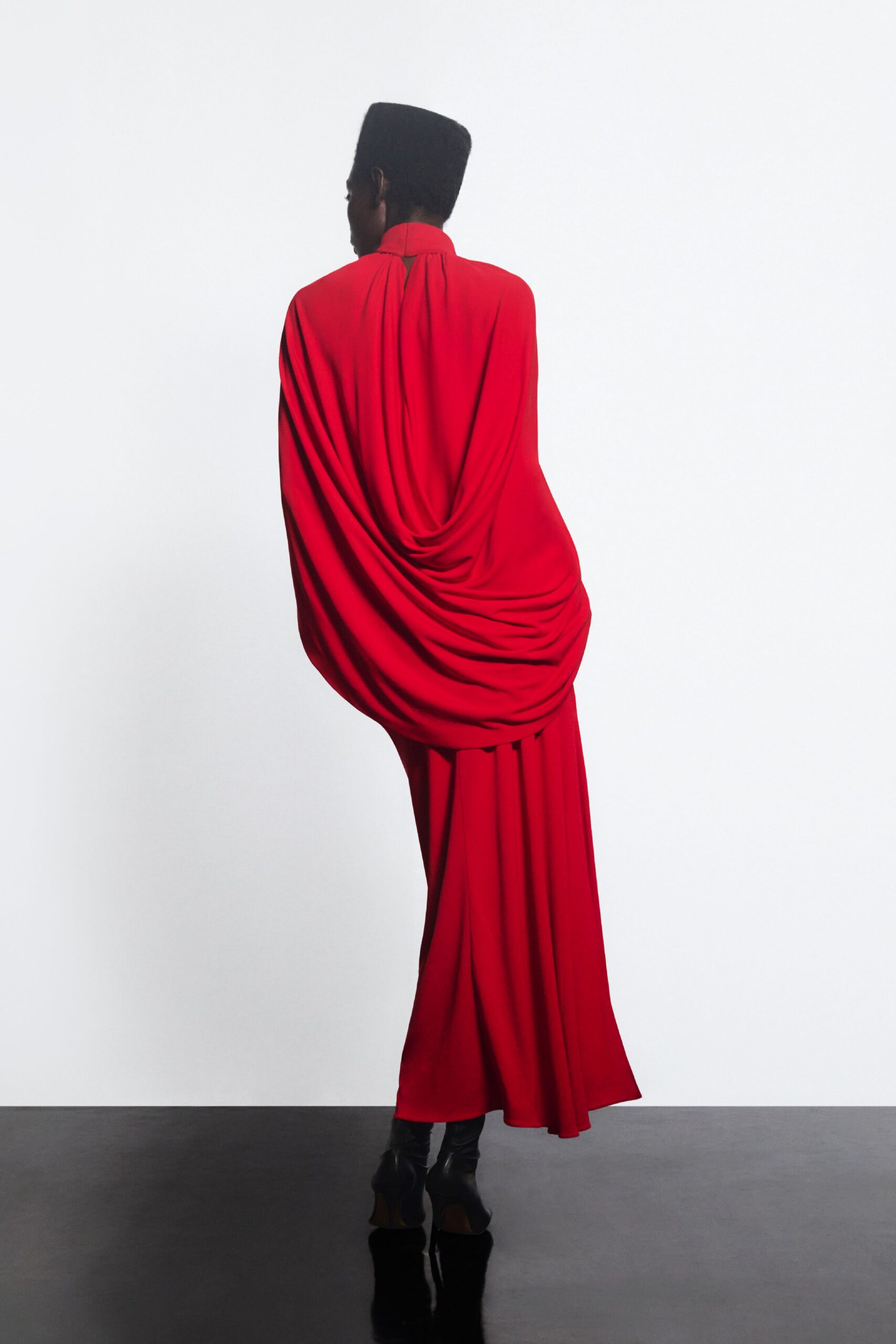 red silk long-sleeve high-neck fitted draped flowing gown