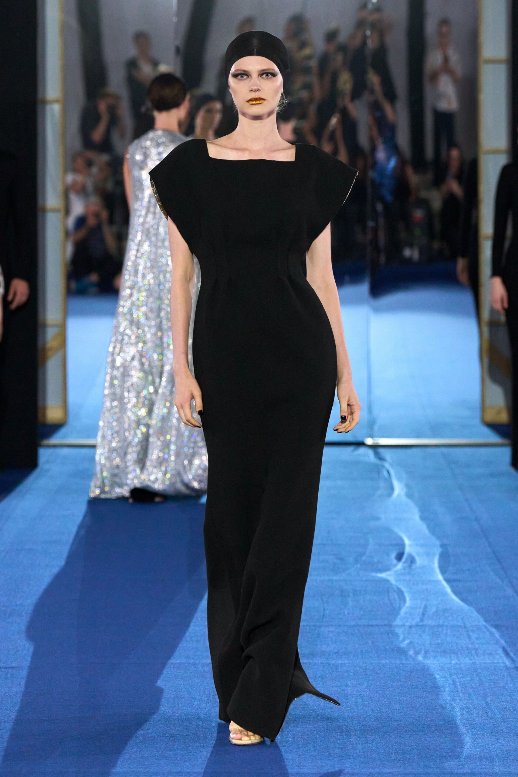 black fitted gown with open-toe shoes