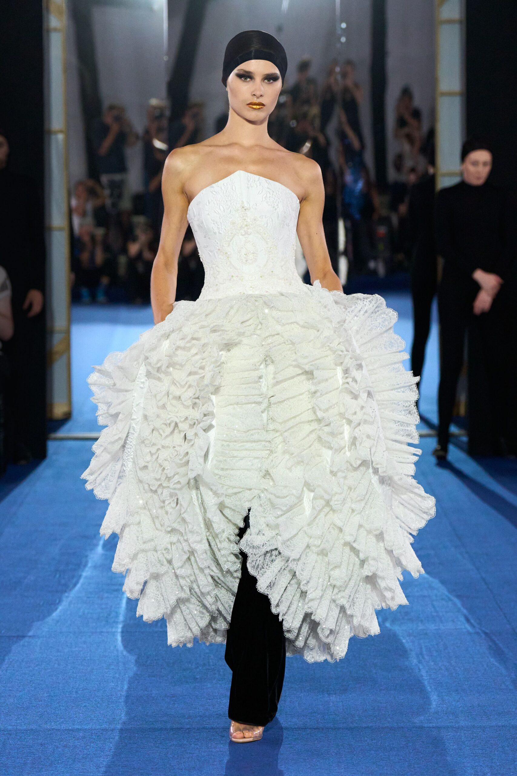 white lace strapless gown with black pants