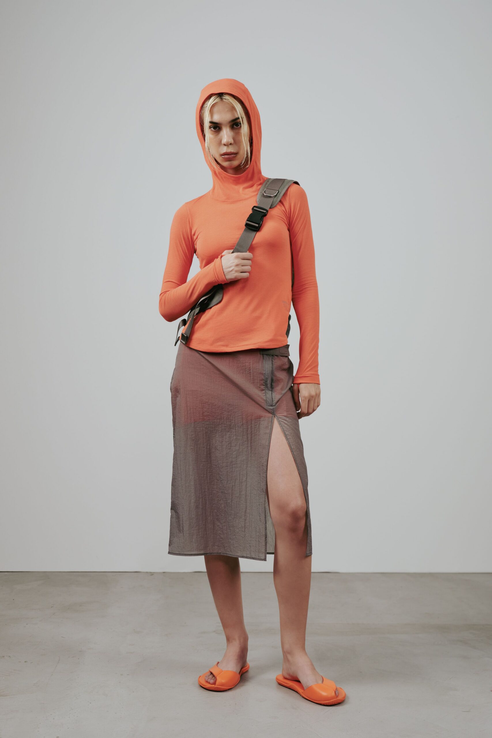 orange hooded top with gray skirt