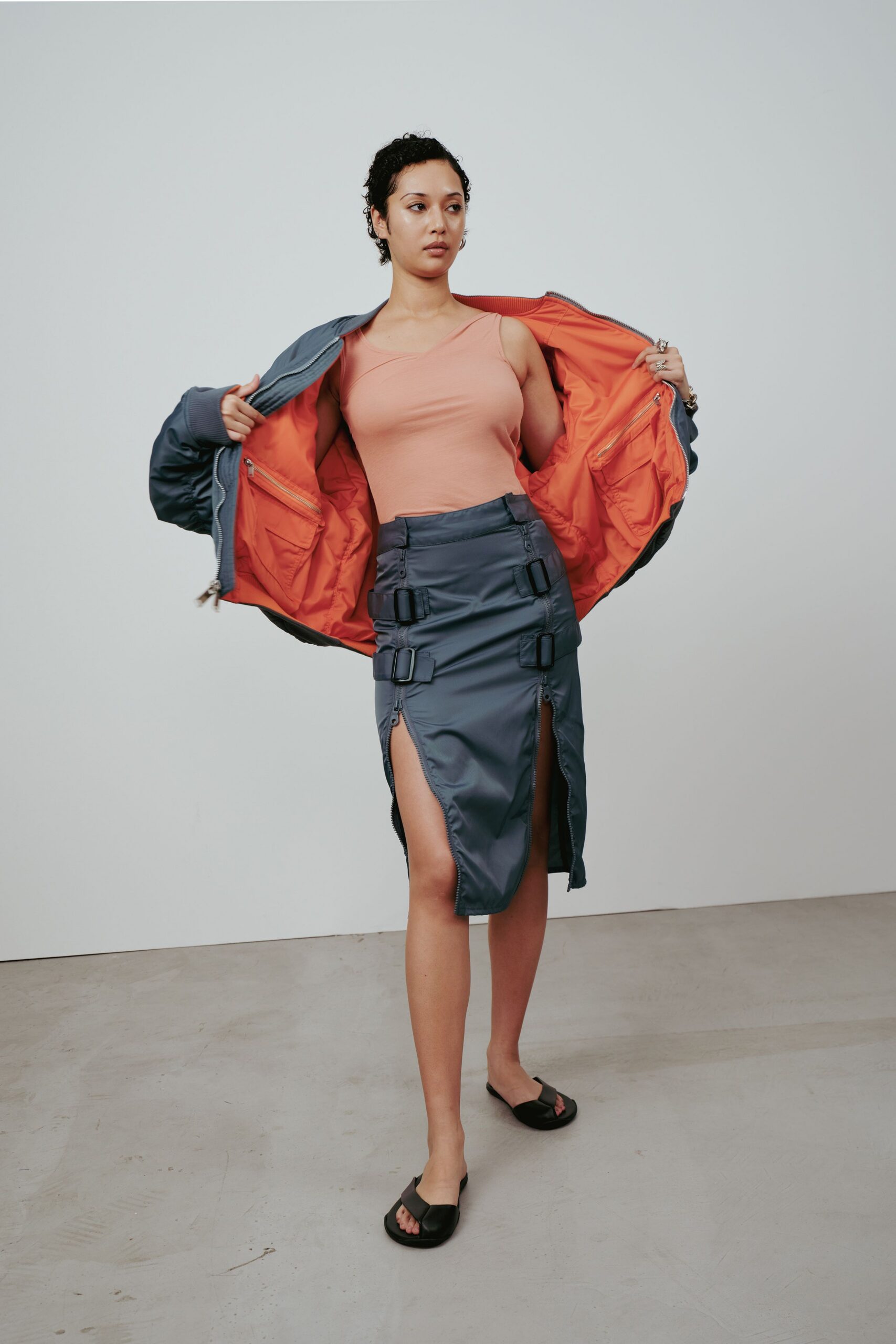 blue jacket orange top blue skirt