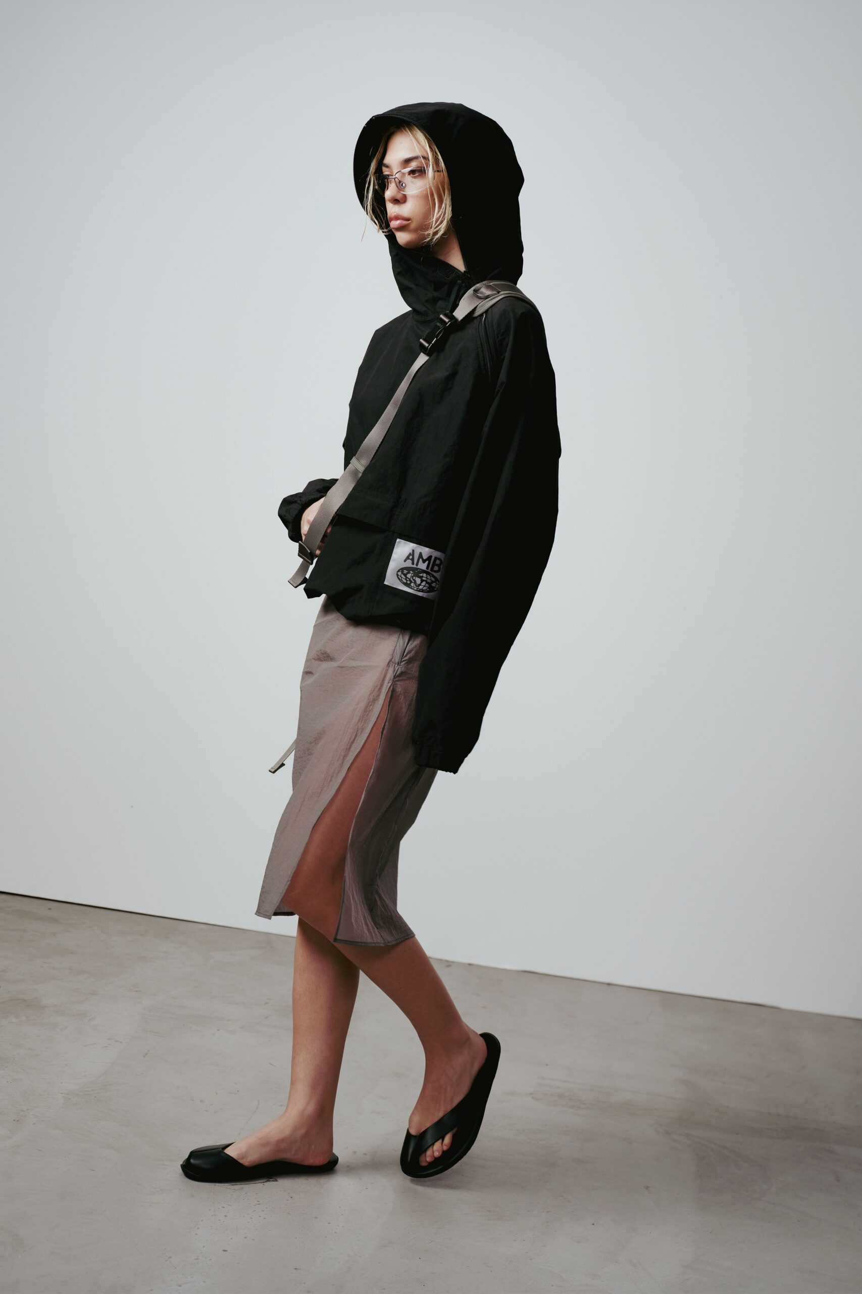black hooded jacket beige skirt