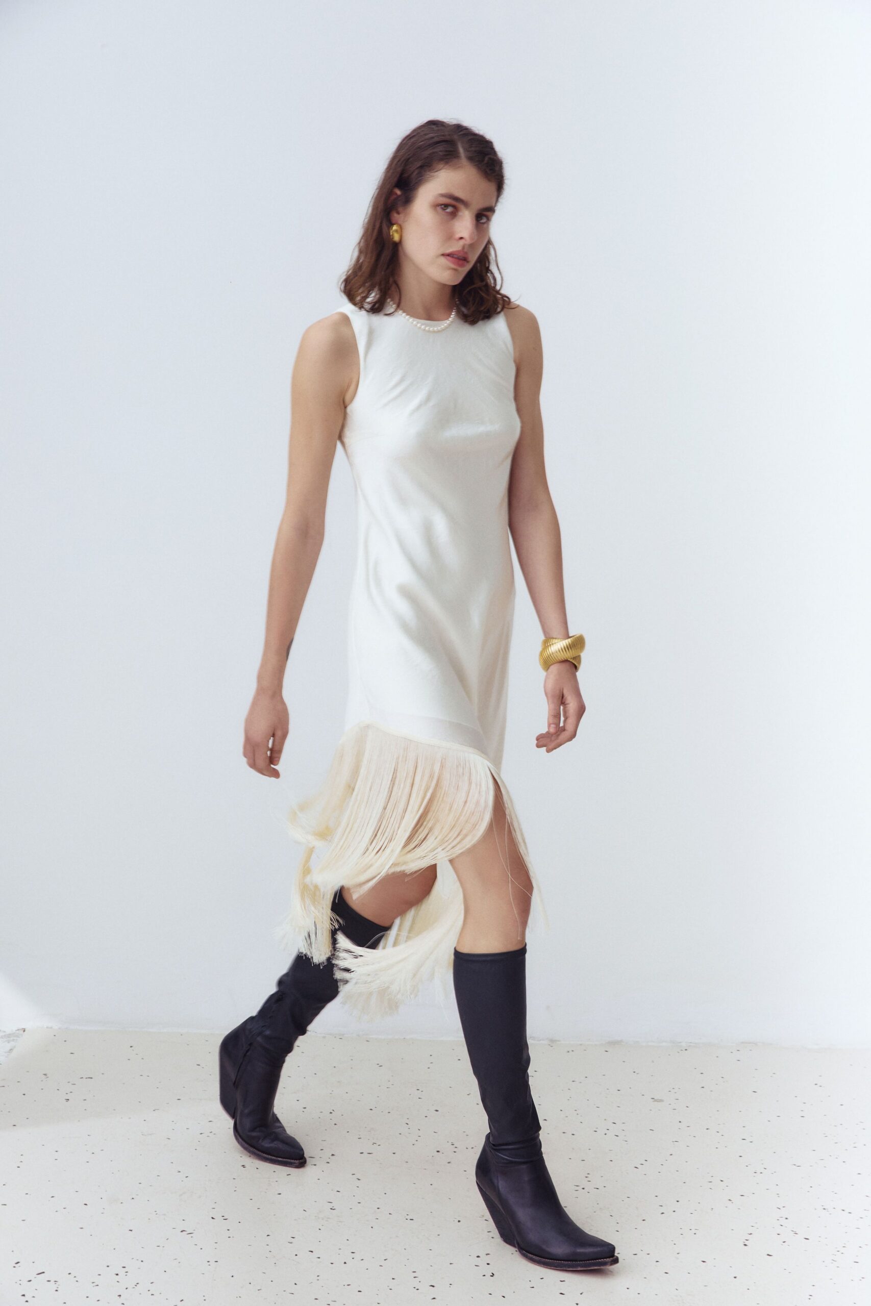 white fringed mini dress with black boots