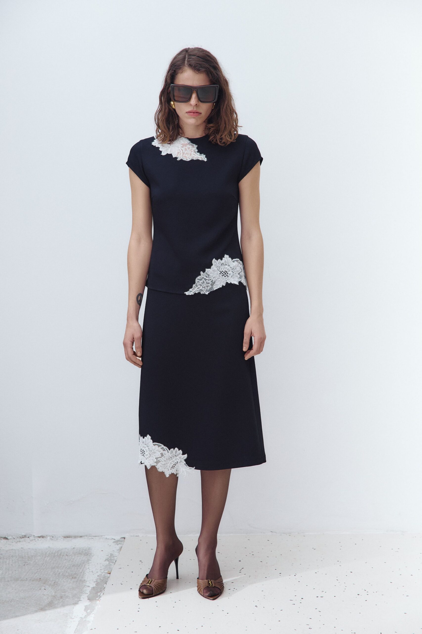 black fitted top and midi skirt