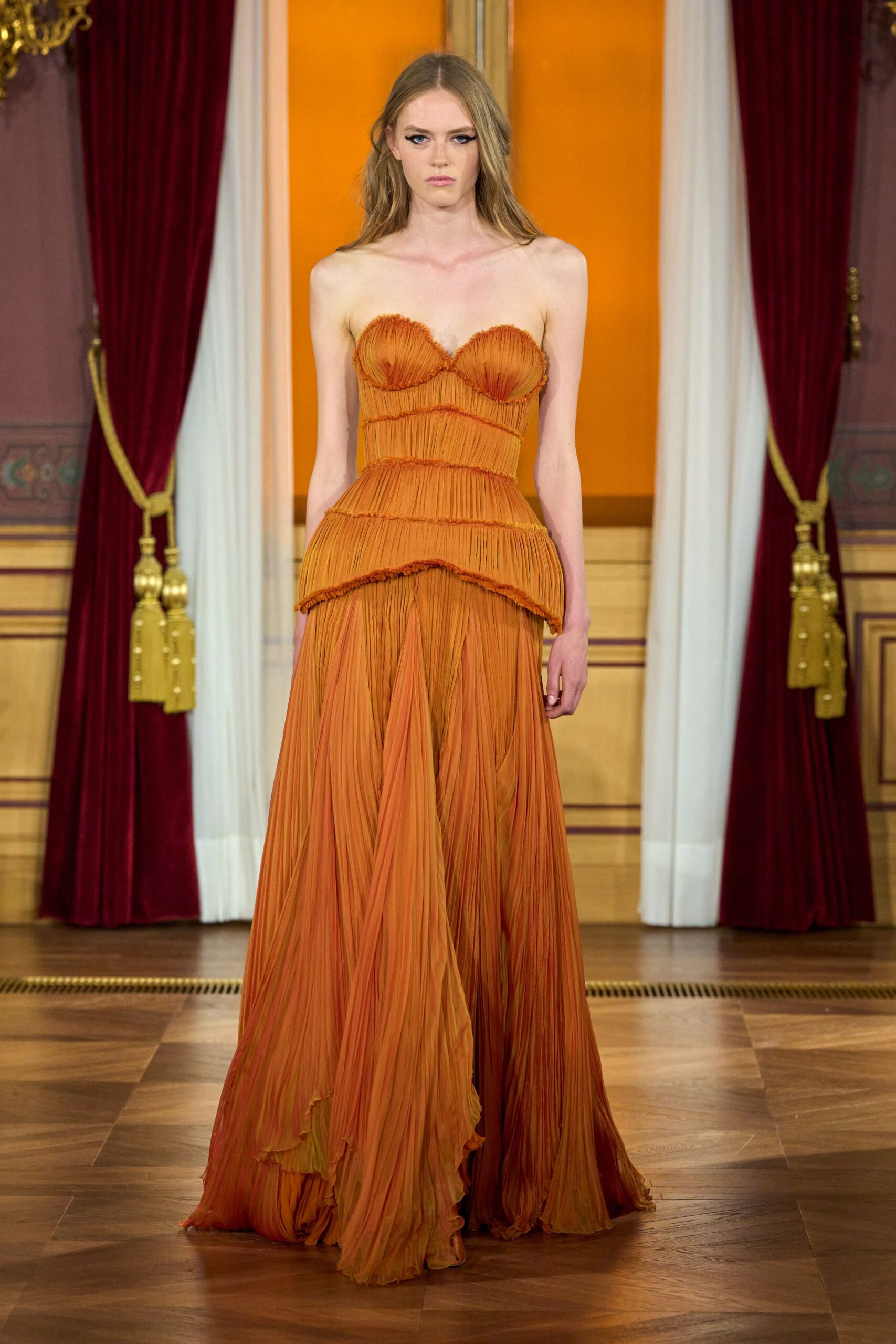 orange pleated strapless gown