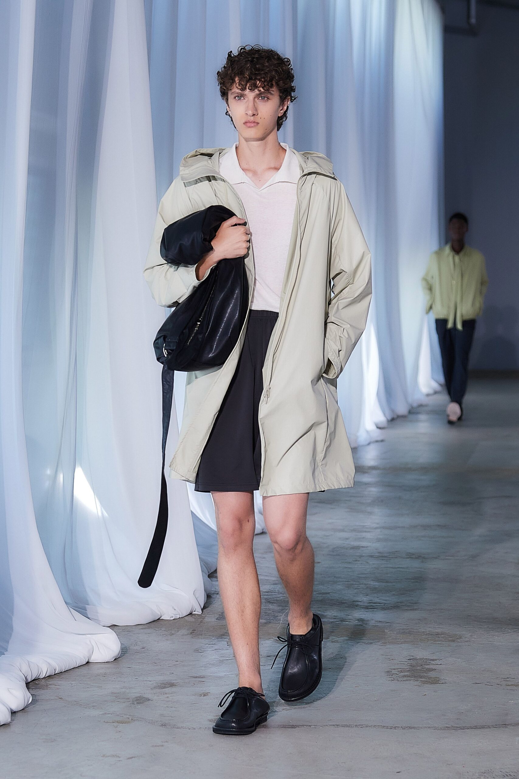 beige coat white shirt black shorts