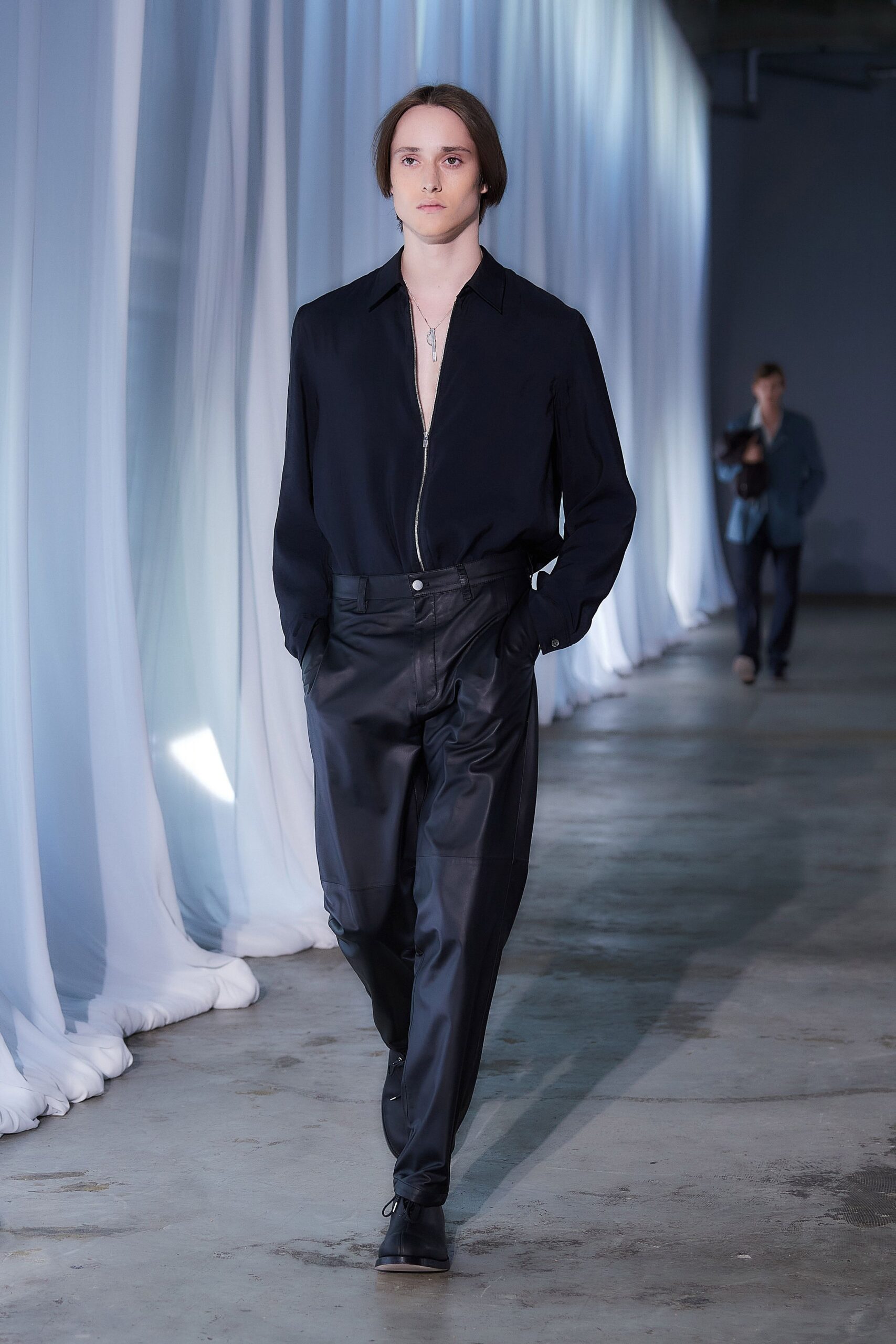 black relaxed shirt and fitted leather pants