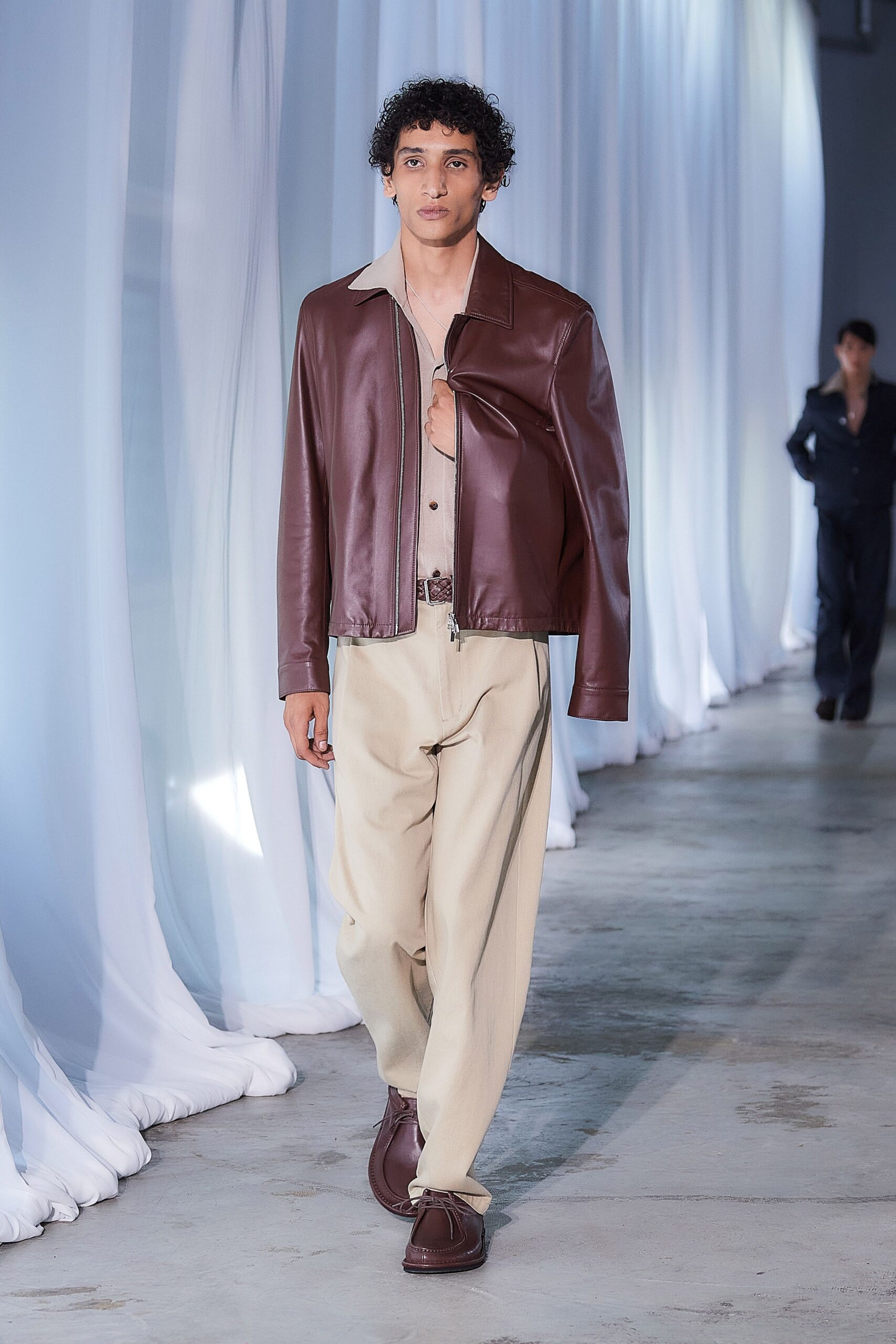 brown leather jacket with beige shirt and pants