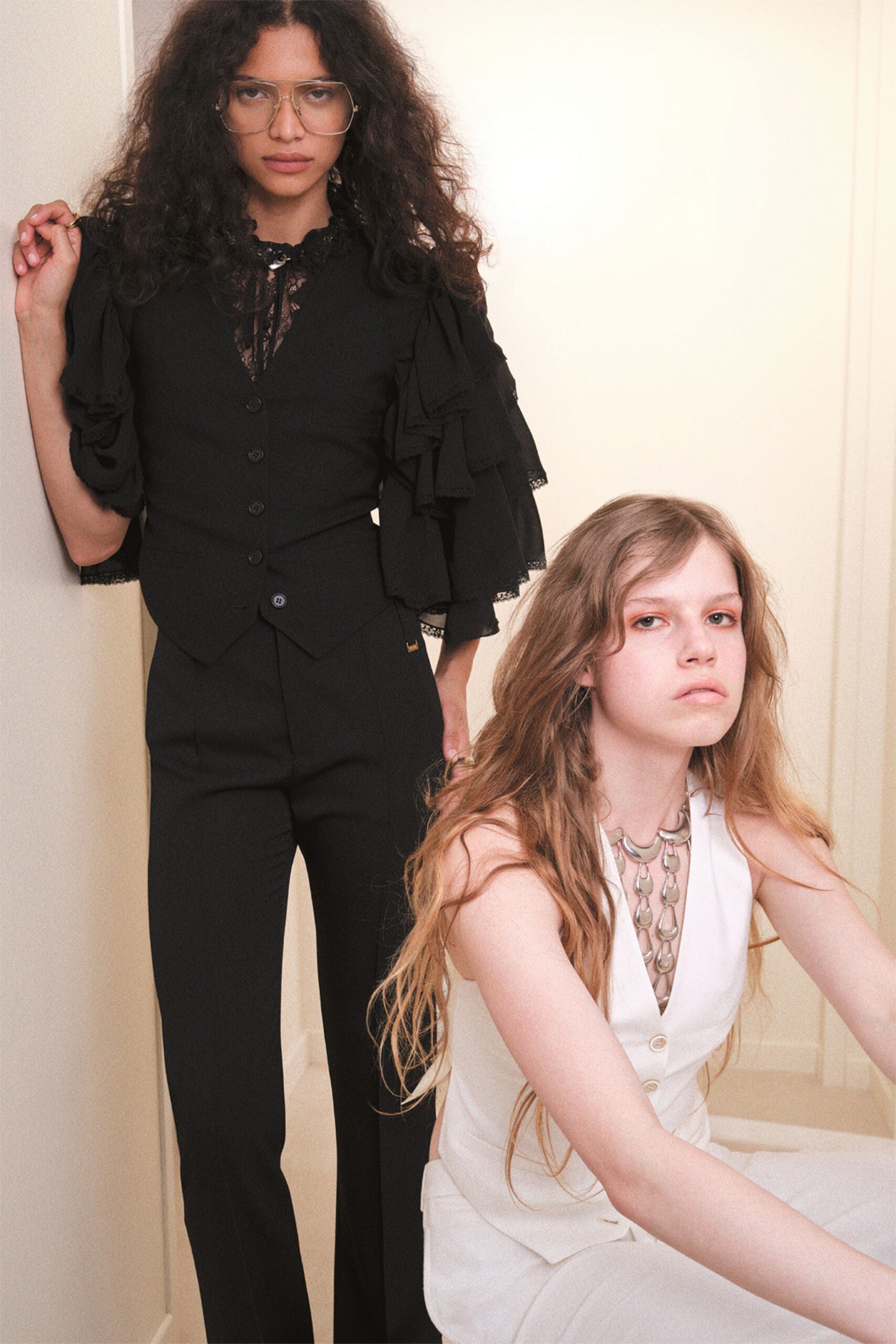 black vest with ruffled sleeves and white dress