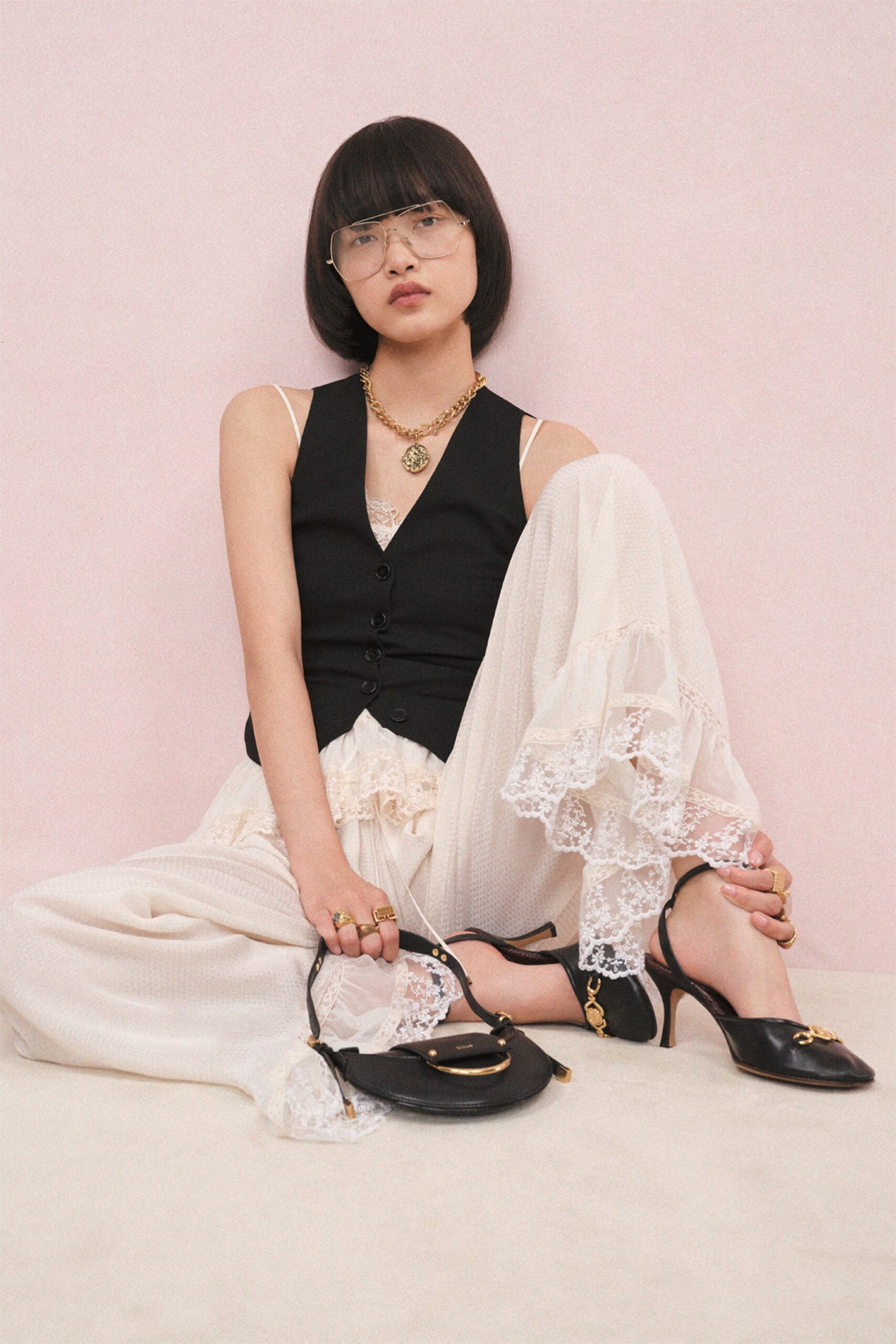 black fitted vest white relaxed pants
