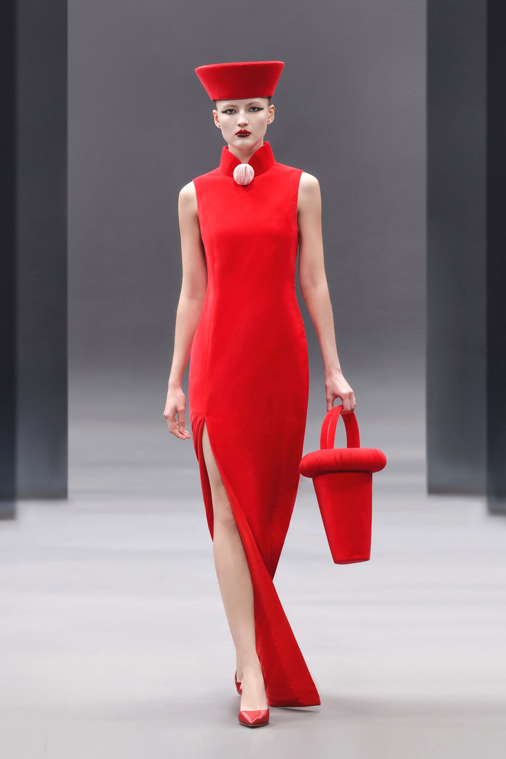 red fitted gown with hat and bag