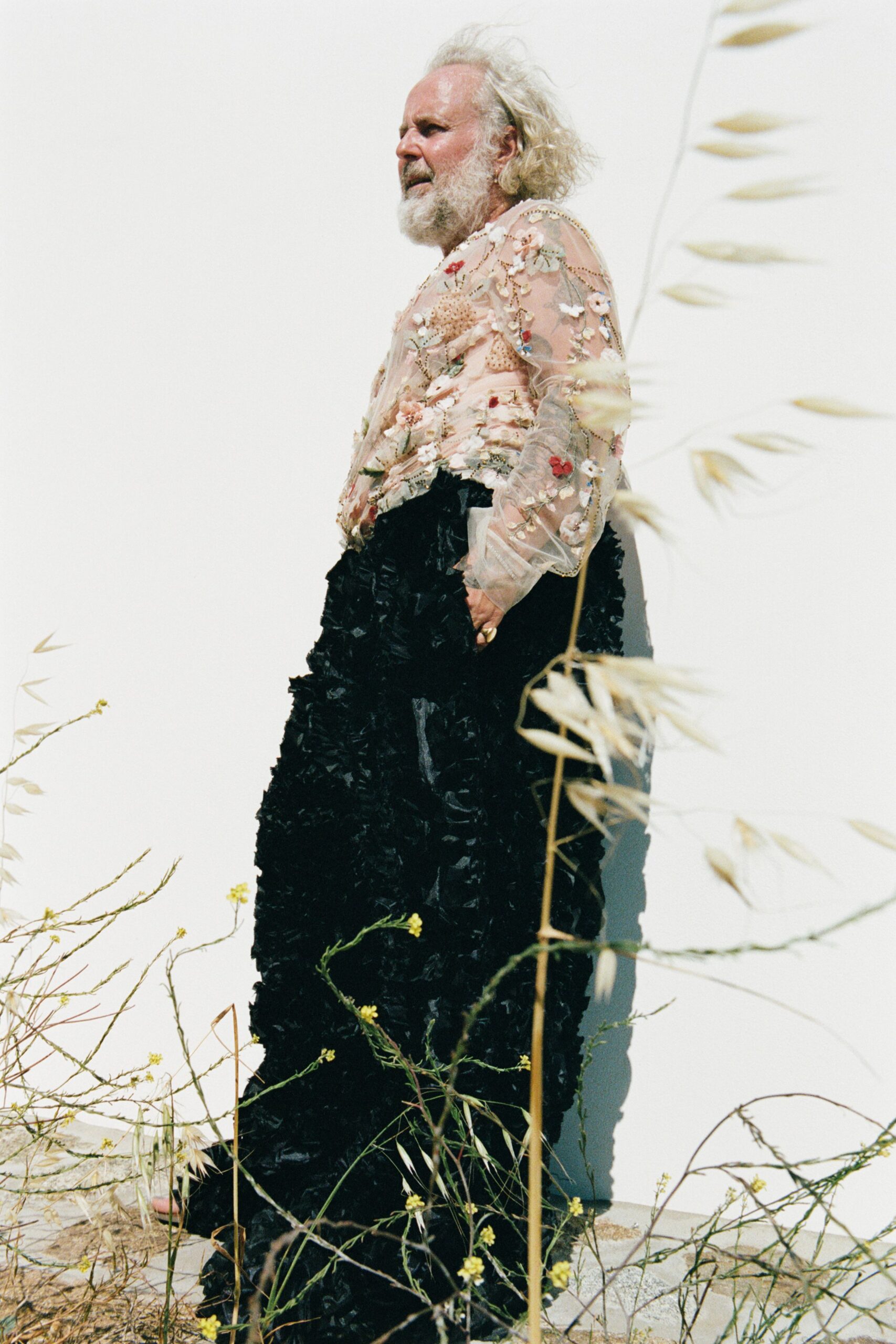 beige embroidered silk top and black ruffled skirt