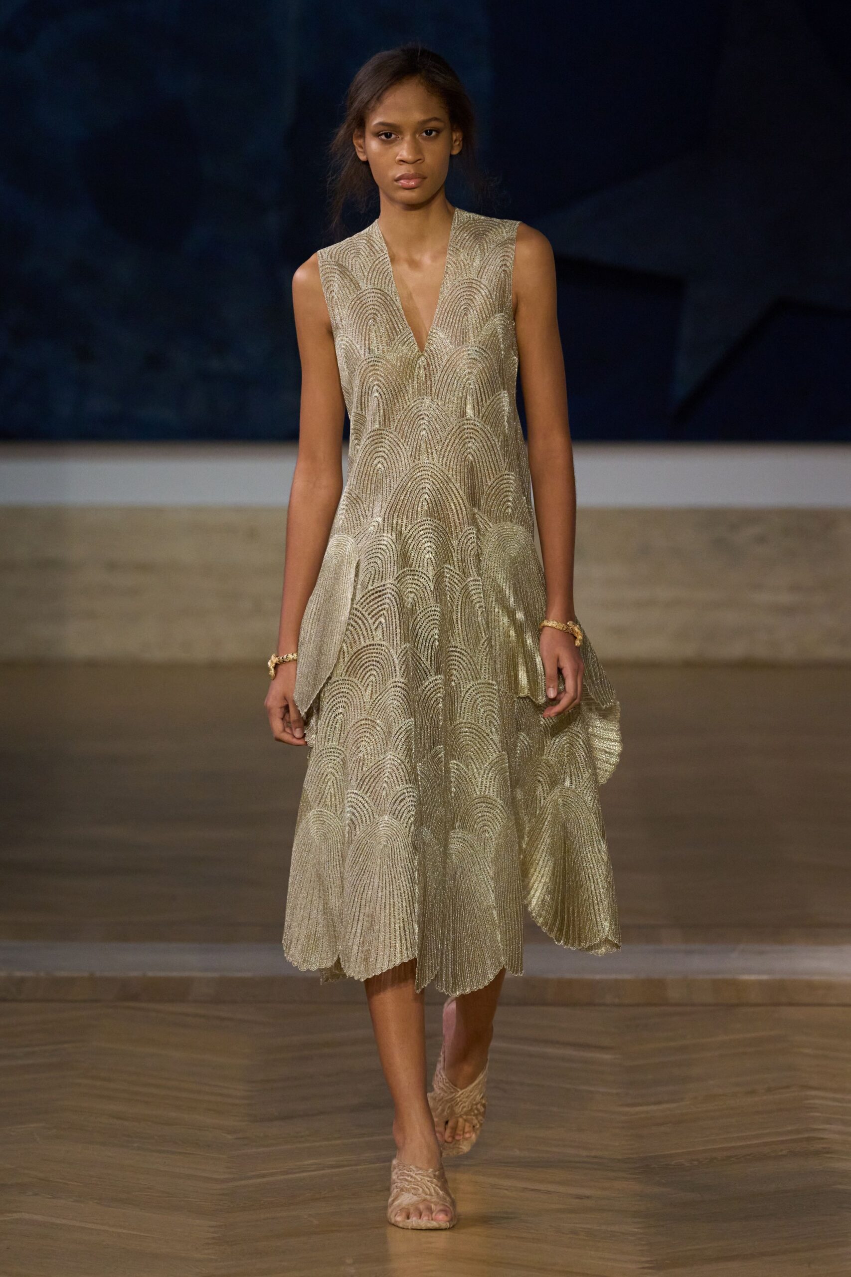gold silk sleeveless v-neck fitted pleated flowing dress