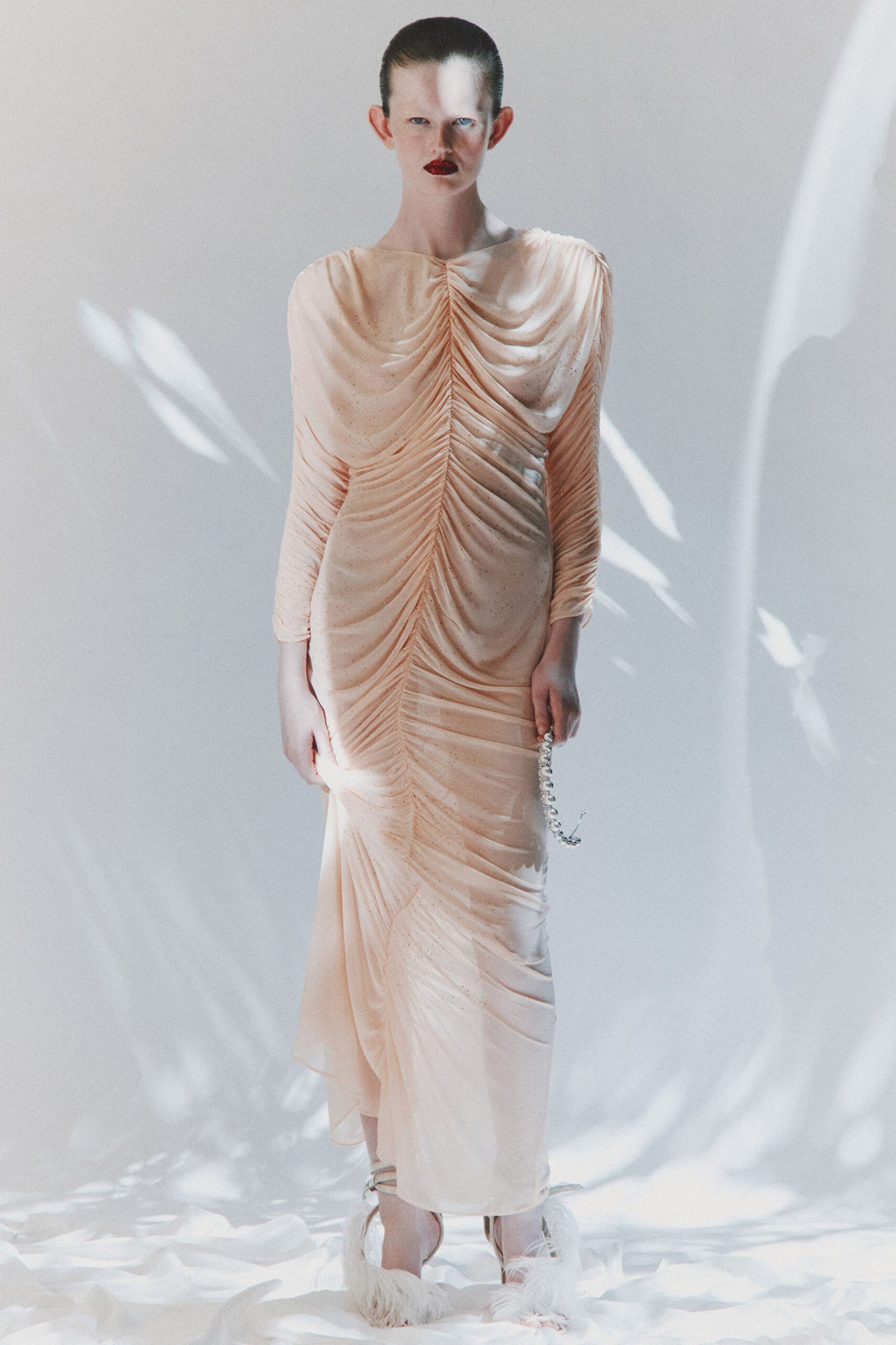 coral silk long-sleeve v-neck fitted ruched sheer gown