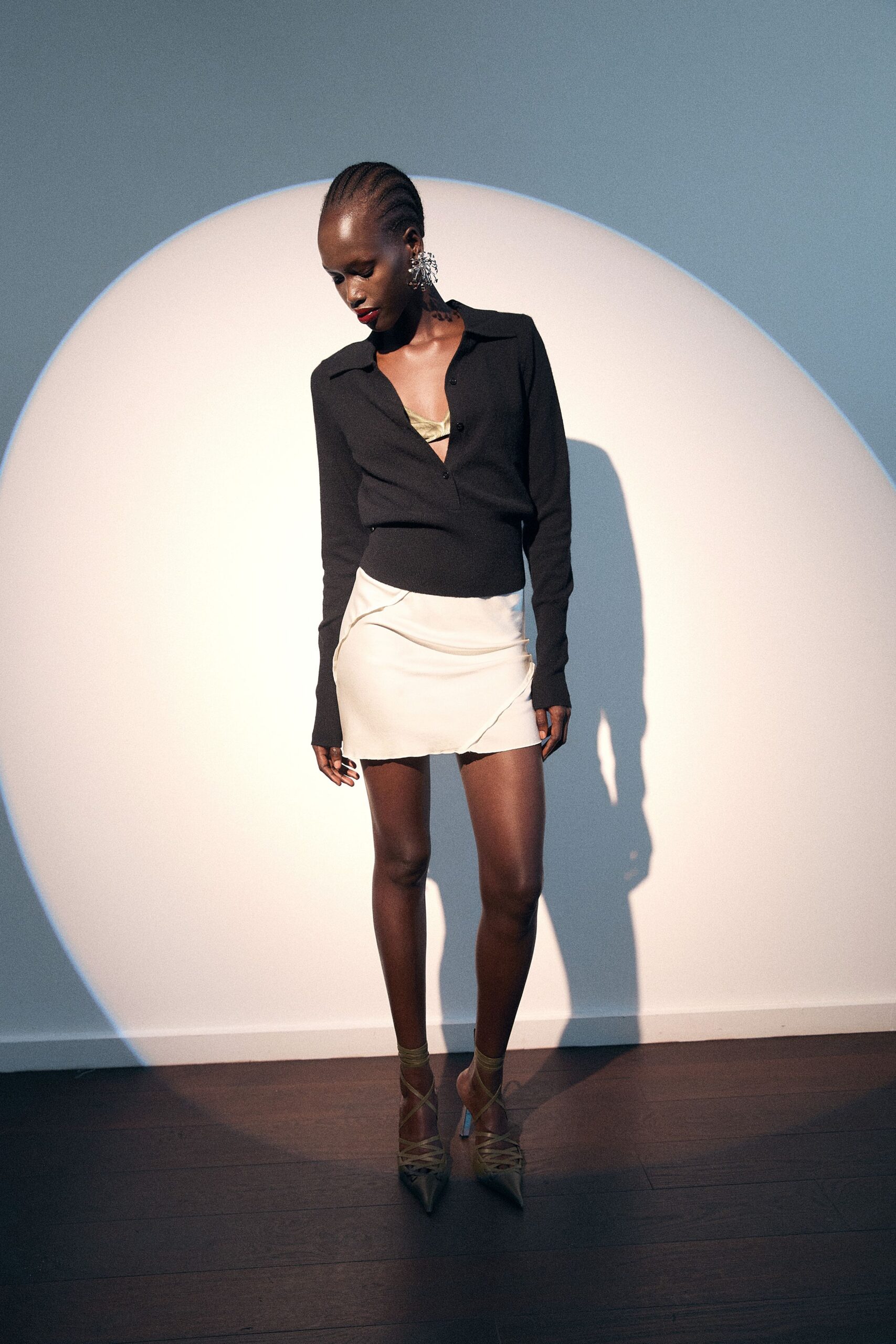 black fitted top with white mini skirt