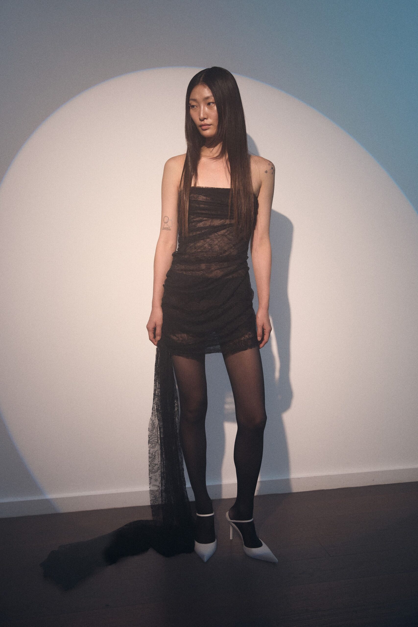 black lace strapless mini dress with white shoes