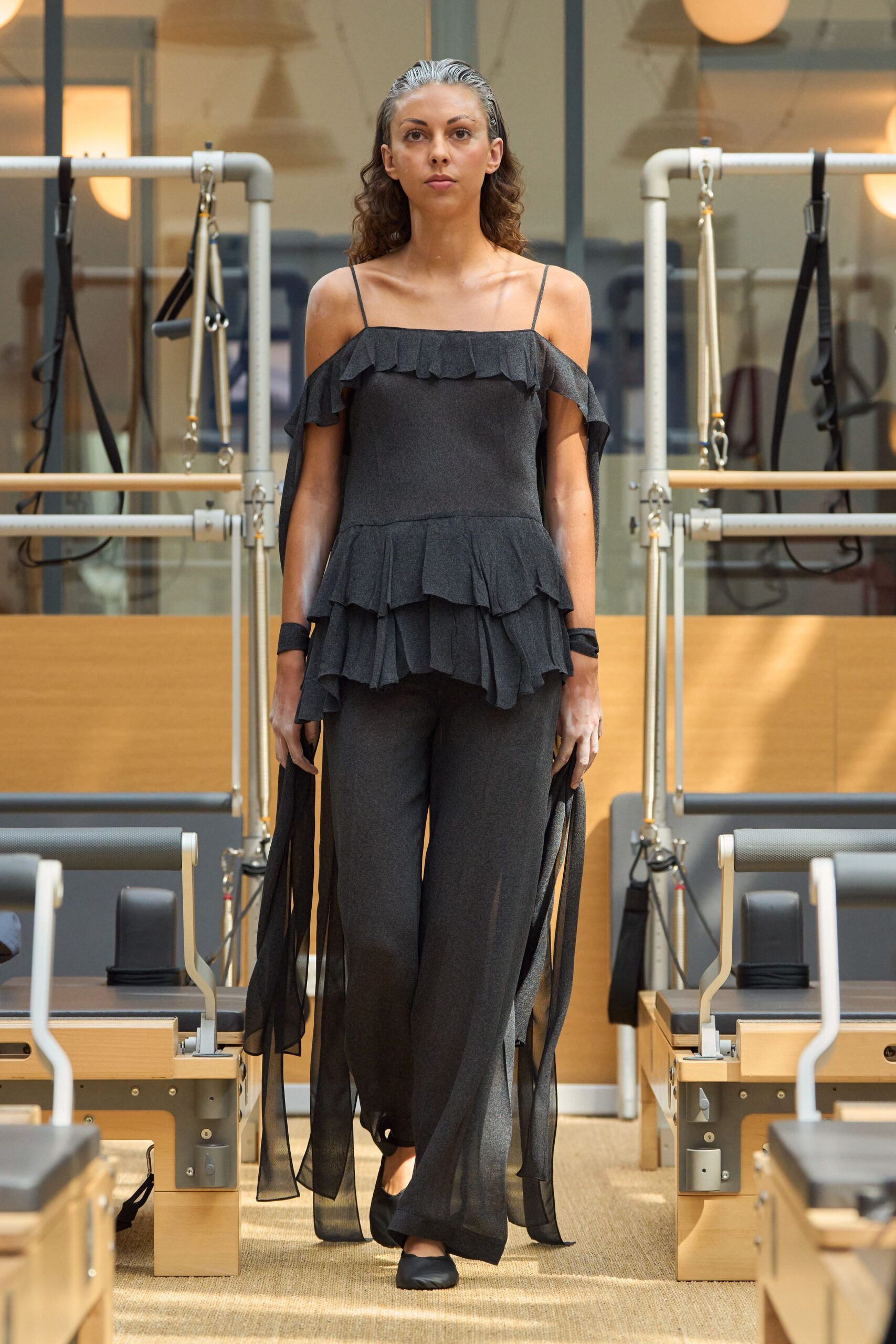 black ruffled top with wide-leg pants