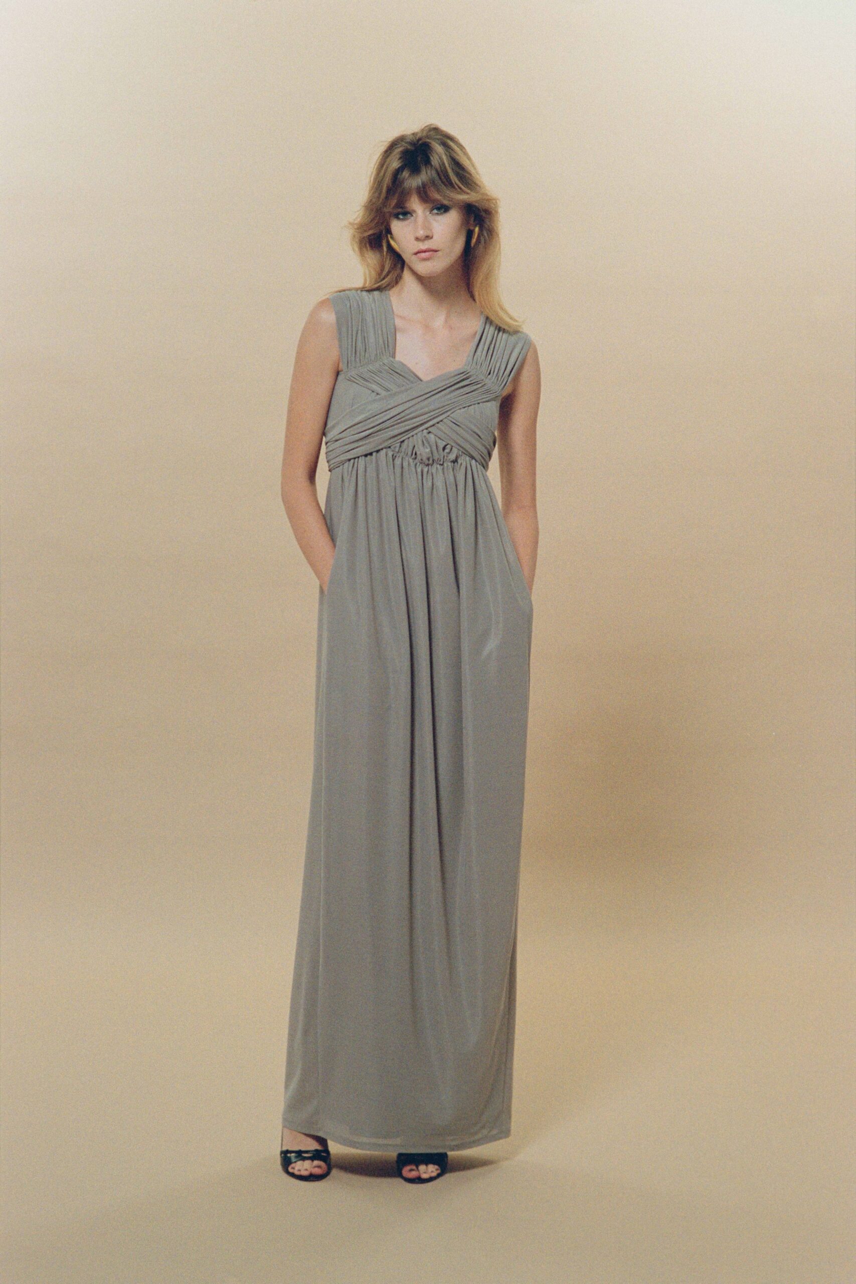 beige silk sleeveless v-neck fitted pleated maxi gown
