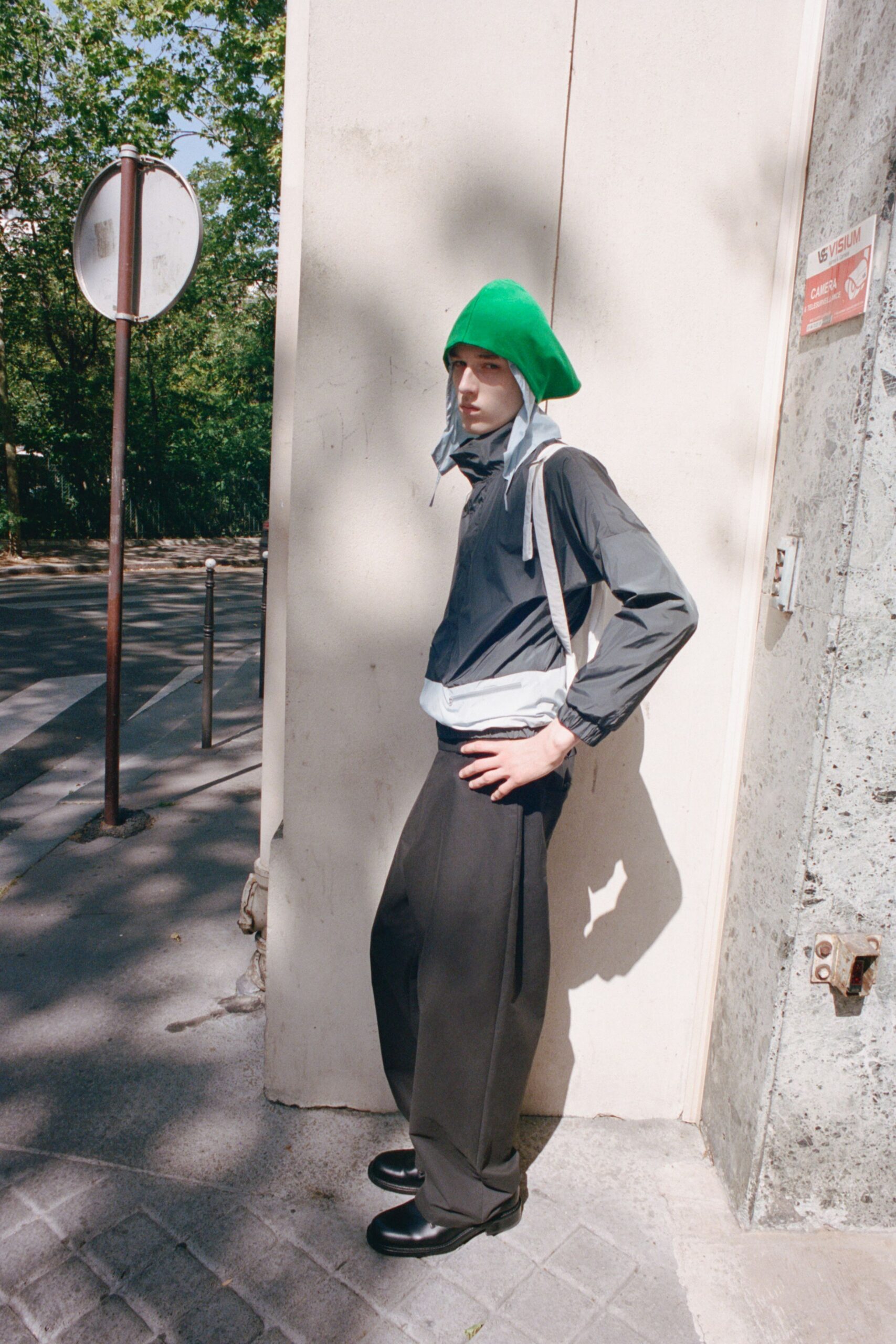 gray jacket with green hat