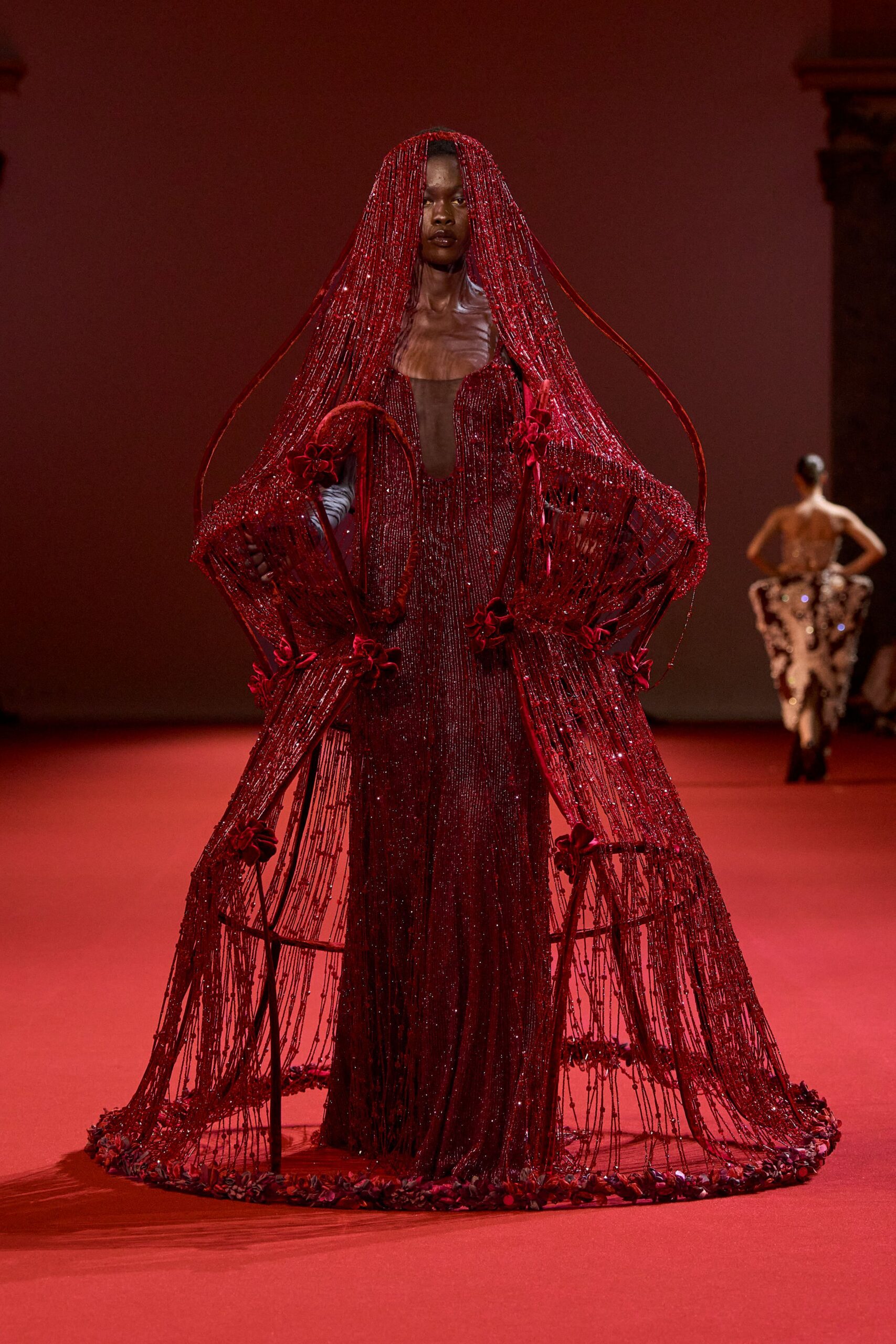 red beaded long-sleeve gown