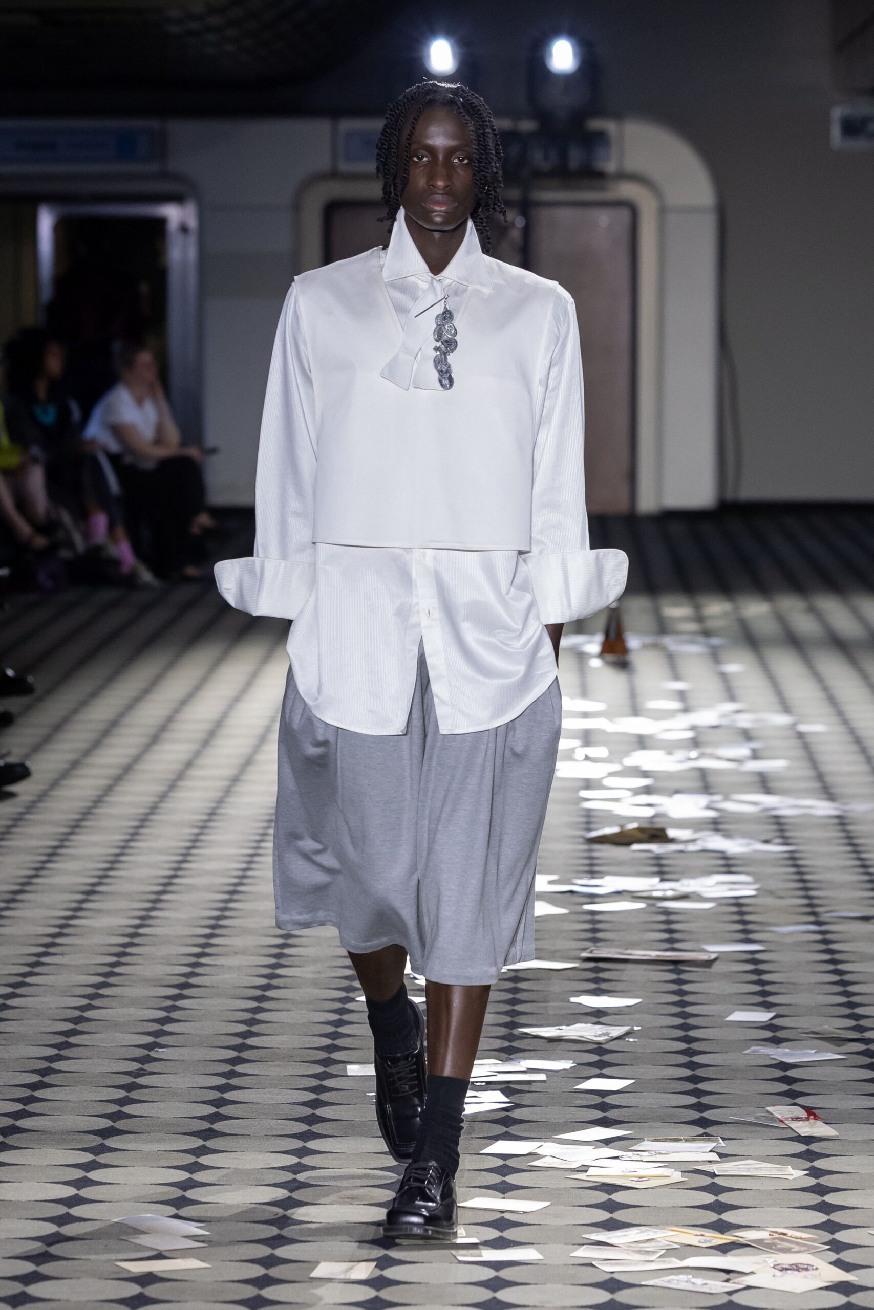 white relaxed shirt gray pleated skirt