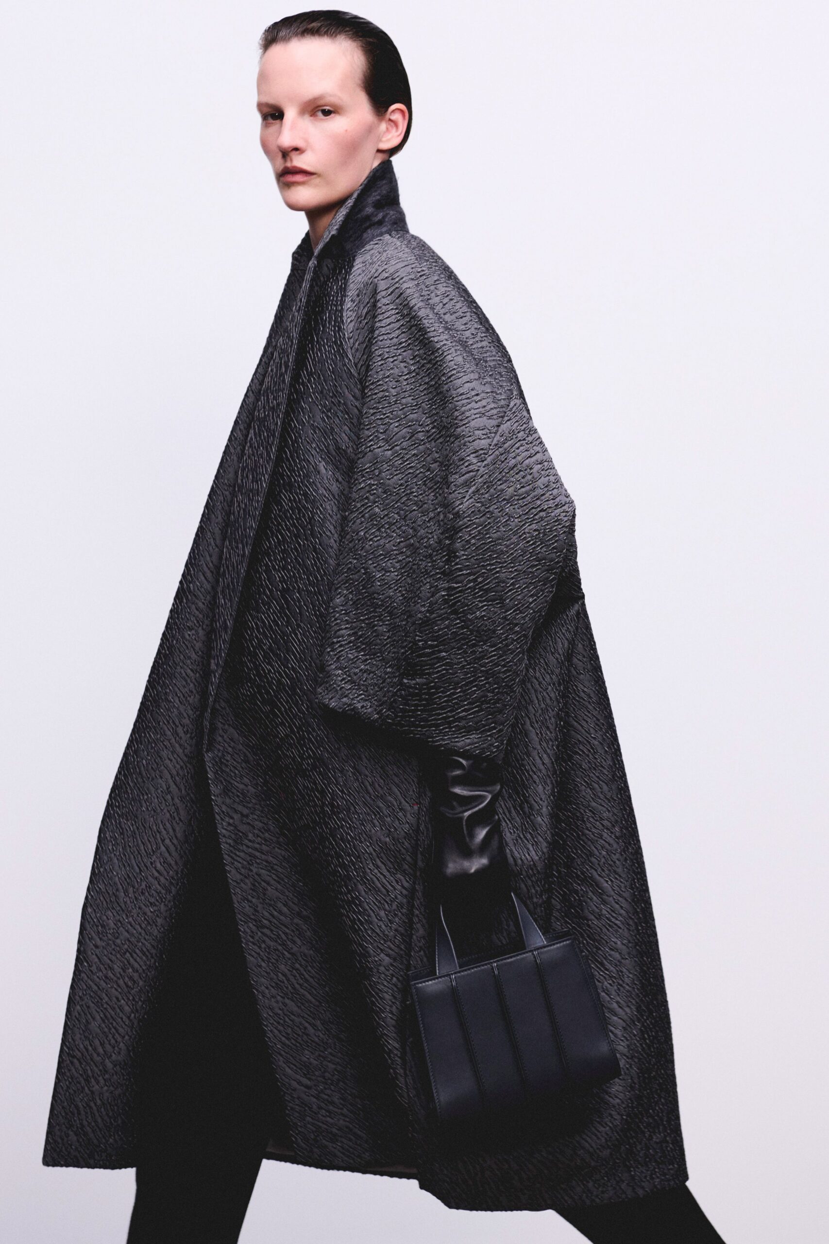 black wool long-sleeve collared oversized textured coat