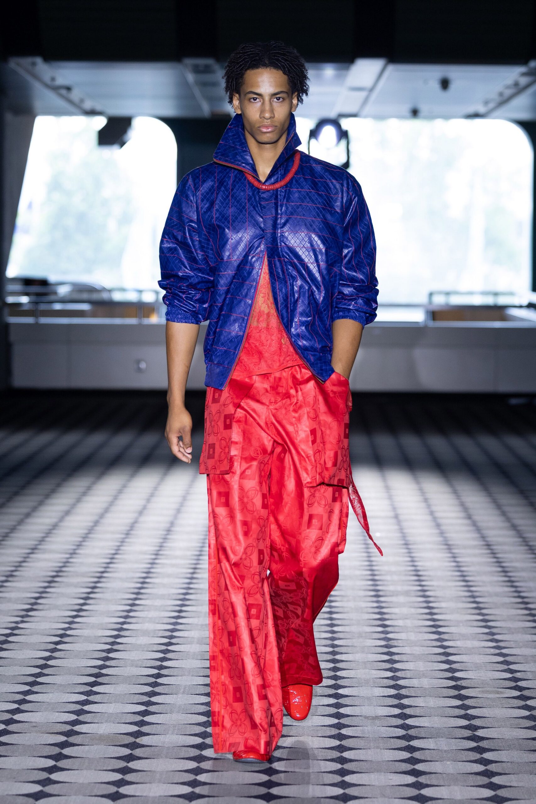 blue vinyl relaxed jacket and red silk pants