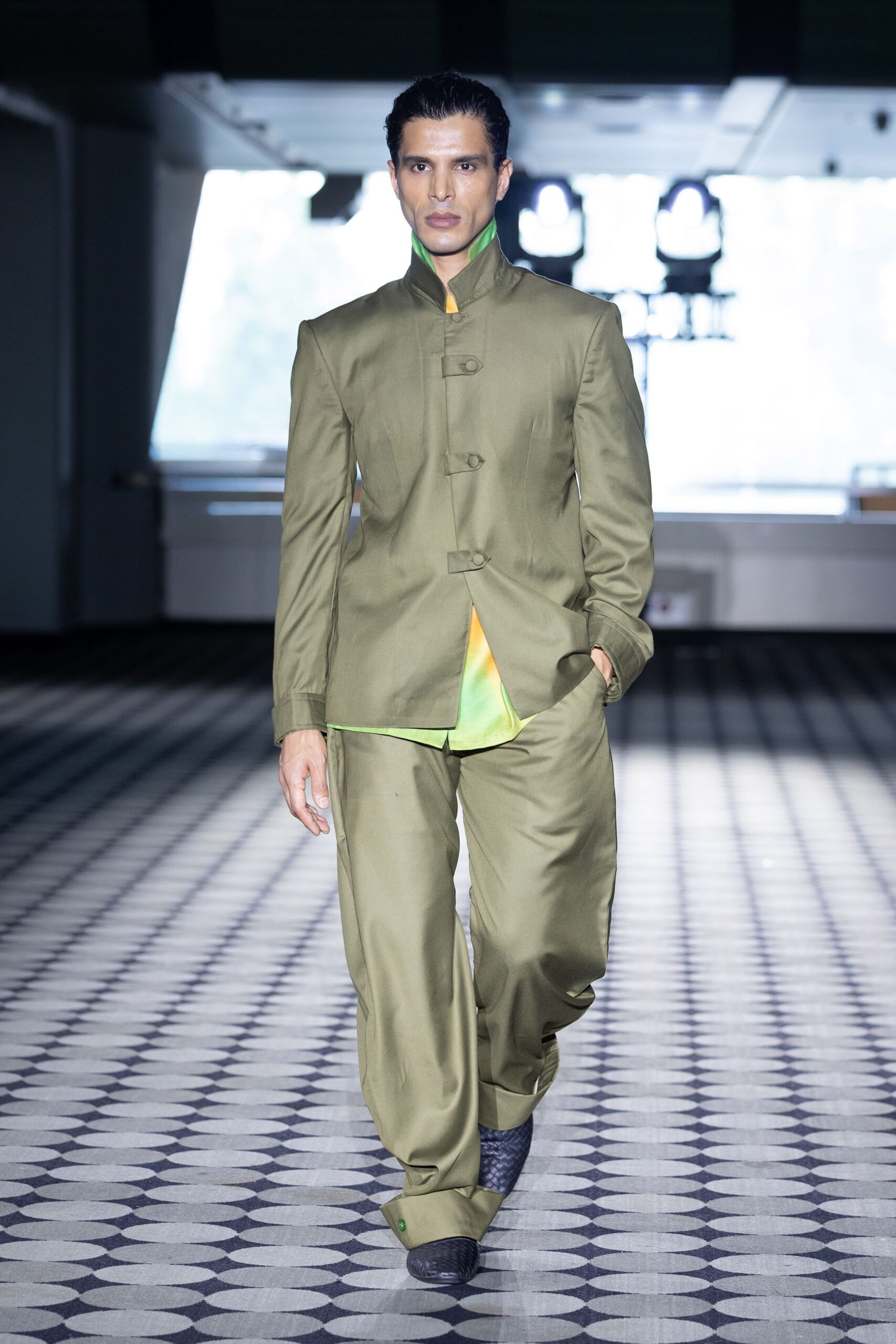 green relaxed suit with black shoes