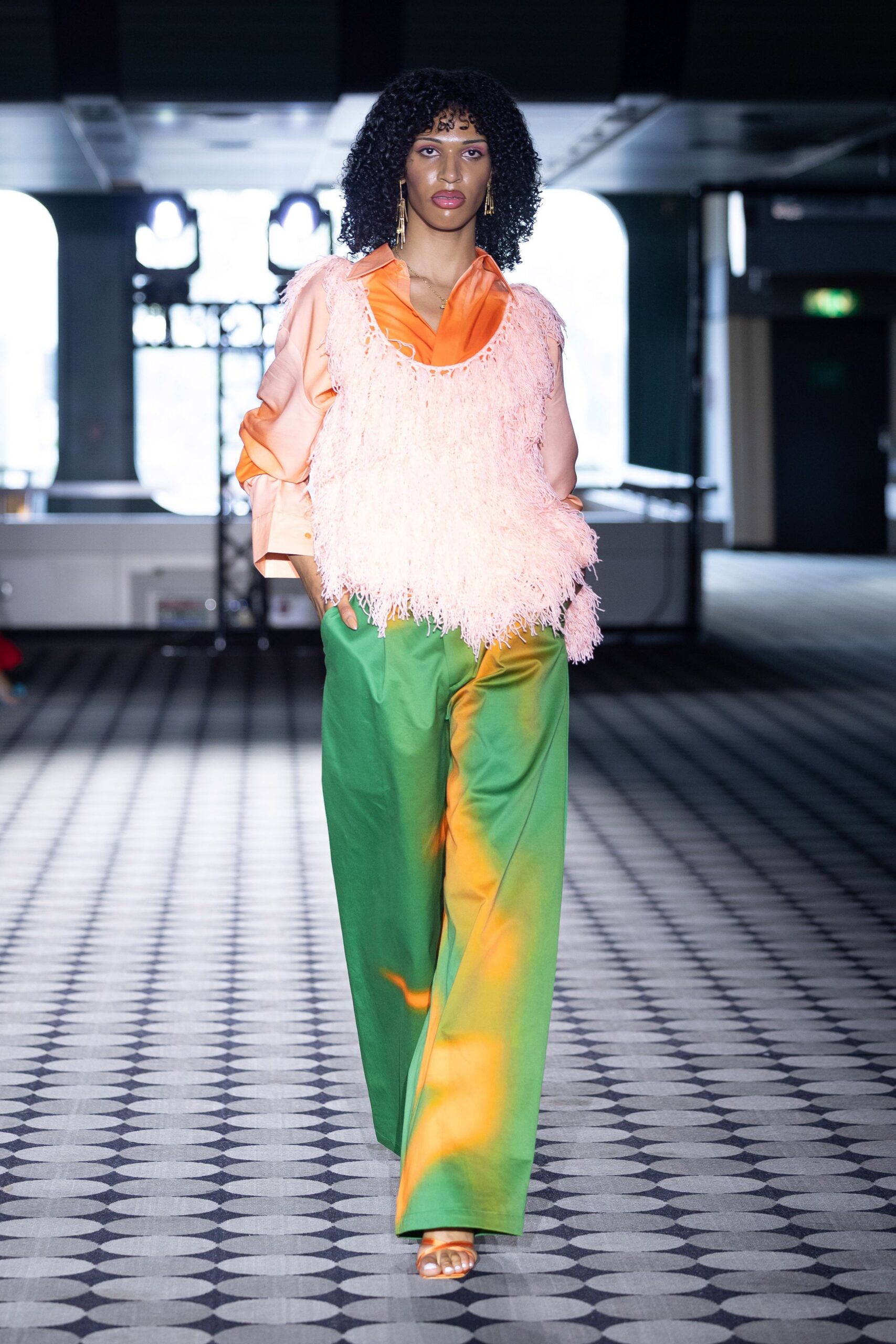 pink fringed top green pants