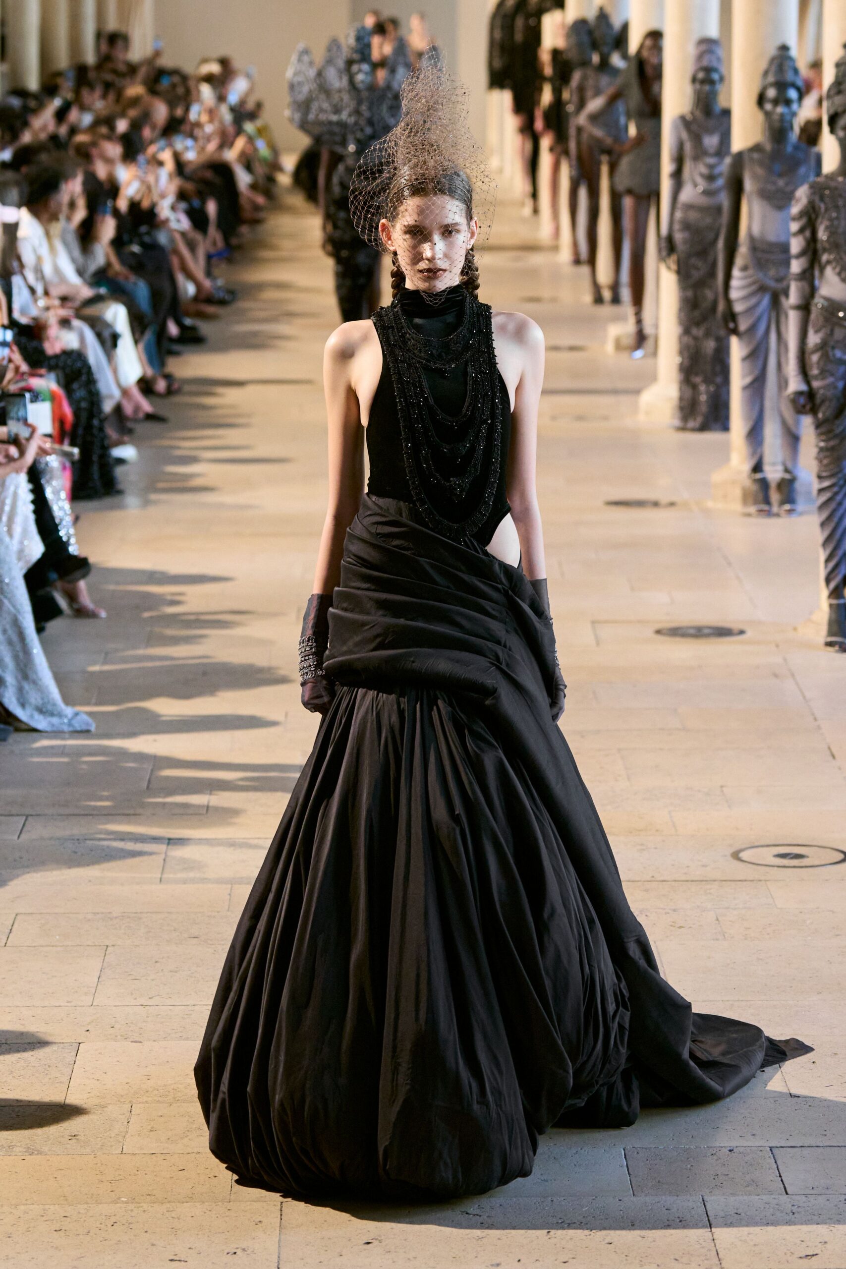 black silk sleeveless high-neck fitted pleated layered gown