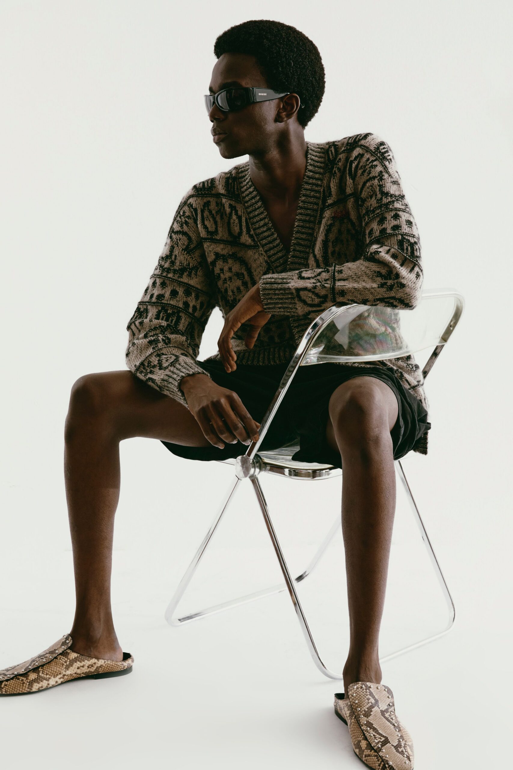 brown printed sweater with black shorts
