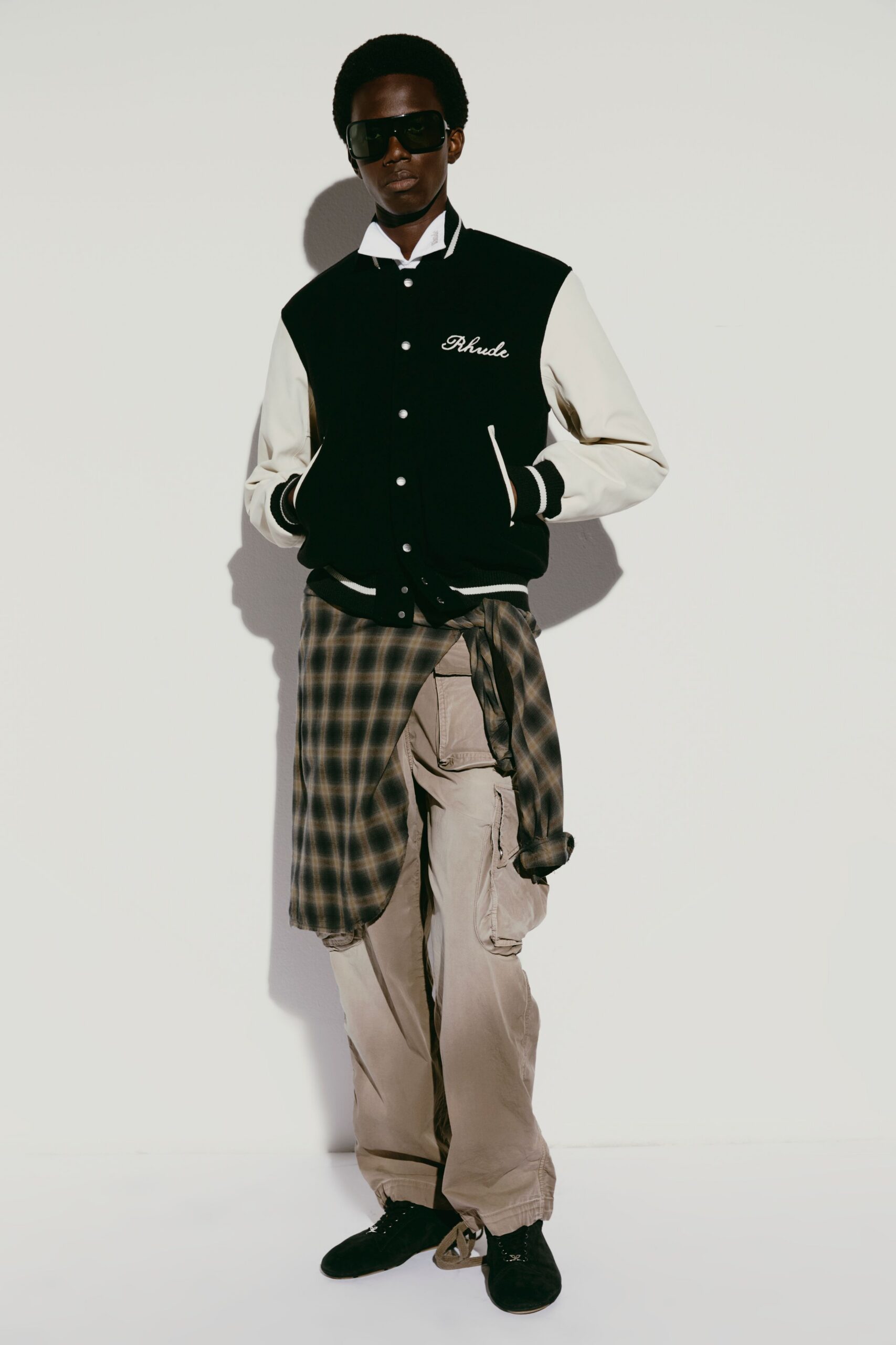 black and white varsity jacket with cargo pants